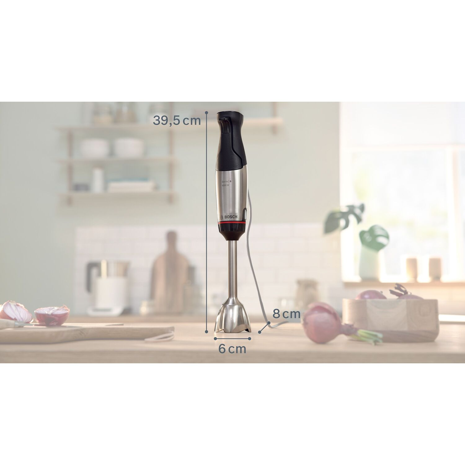 Hand blender with dimensions shown, on a wooden surface. Red onions are visible.