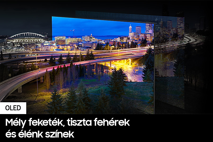 TV képernyő, amely egy városképét mutatja éjszaka, élénk színekkel és szöveggel.