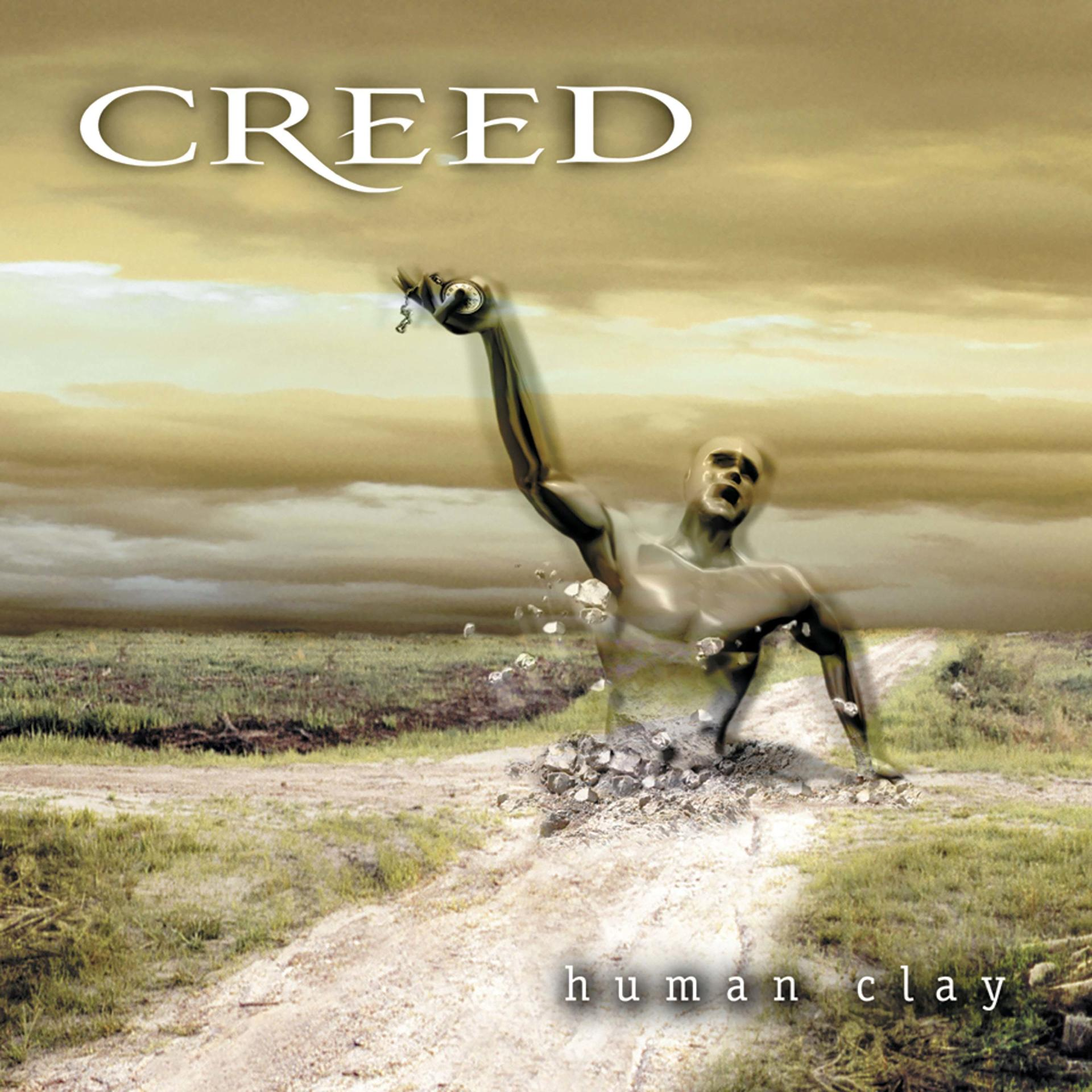 Albumcover. Ein Mann taucht aus dem Boden auf und hebt den Arm. Der Text lautet 'CREED' und 'human clay'.