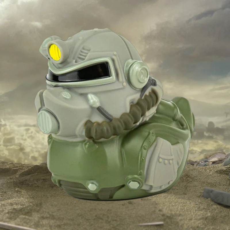 Kacsajáték Fallout témájú Power Armor-ba öltözve. A játék homályos háttéren van.