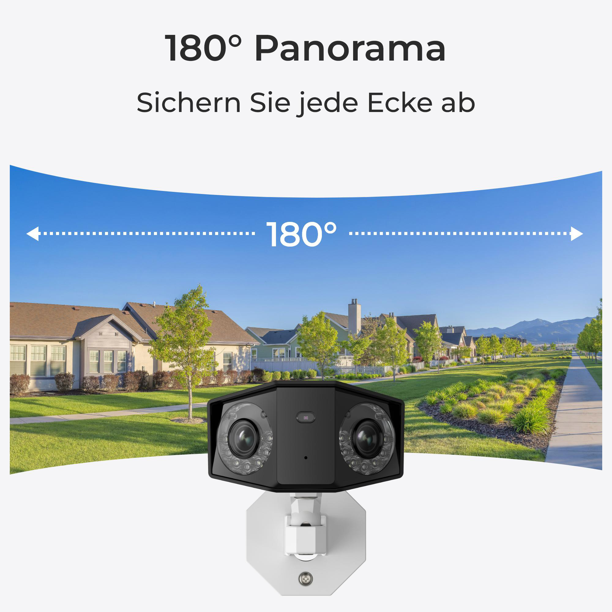Eine schwarze Überwachungskamera an einer weißen Wand, mit Blick auf eine Vorortsiedlung.