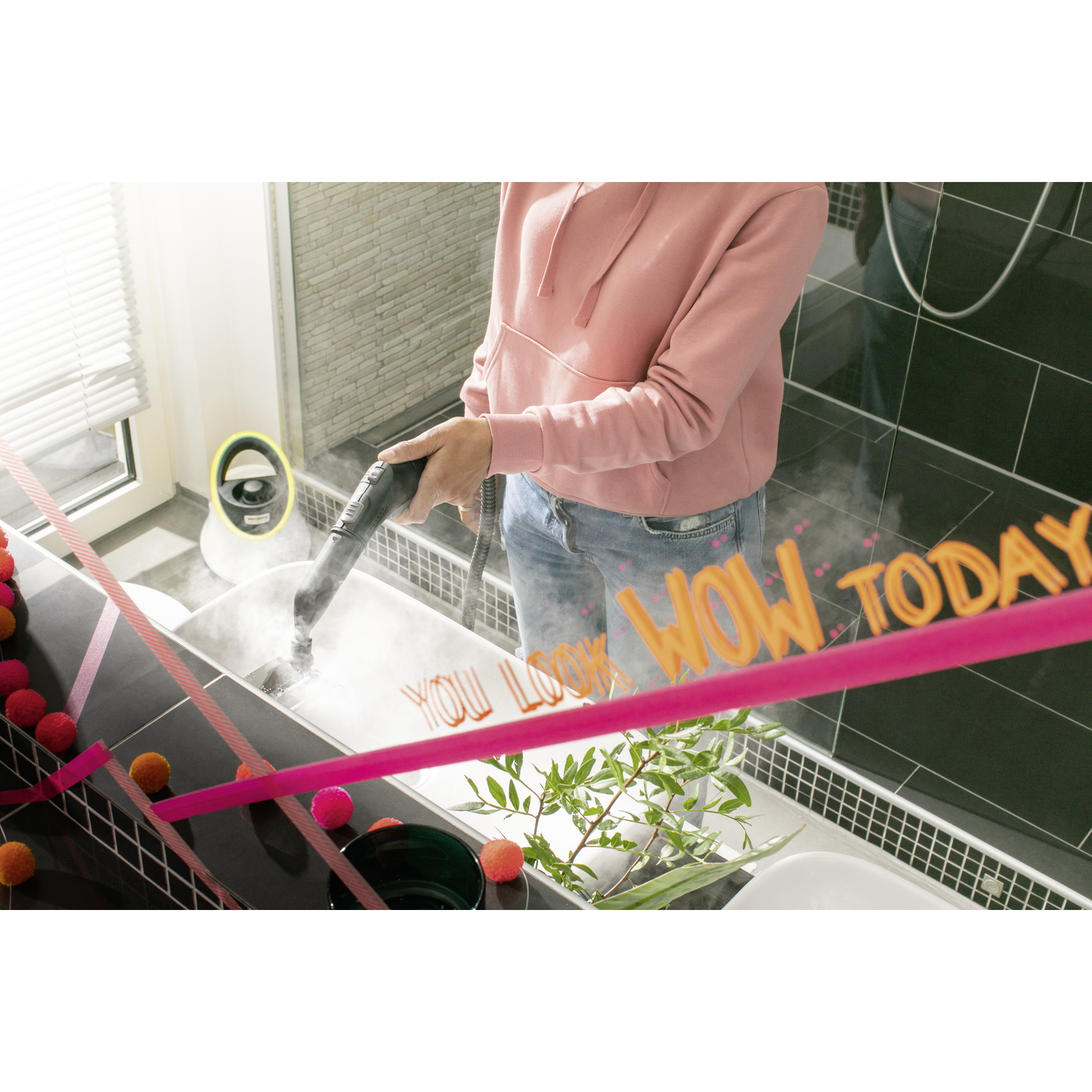 Woman cleaning a bathroom with a steam cleaner, colorful text overlays.