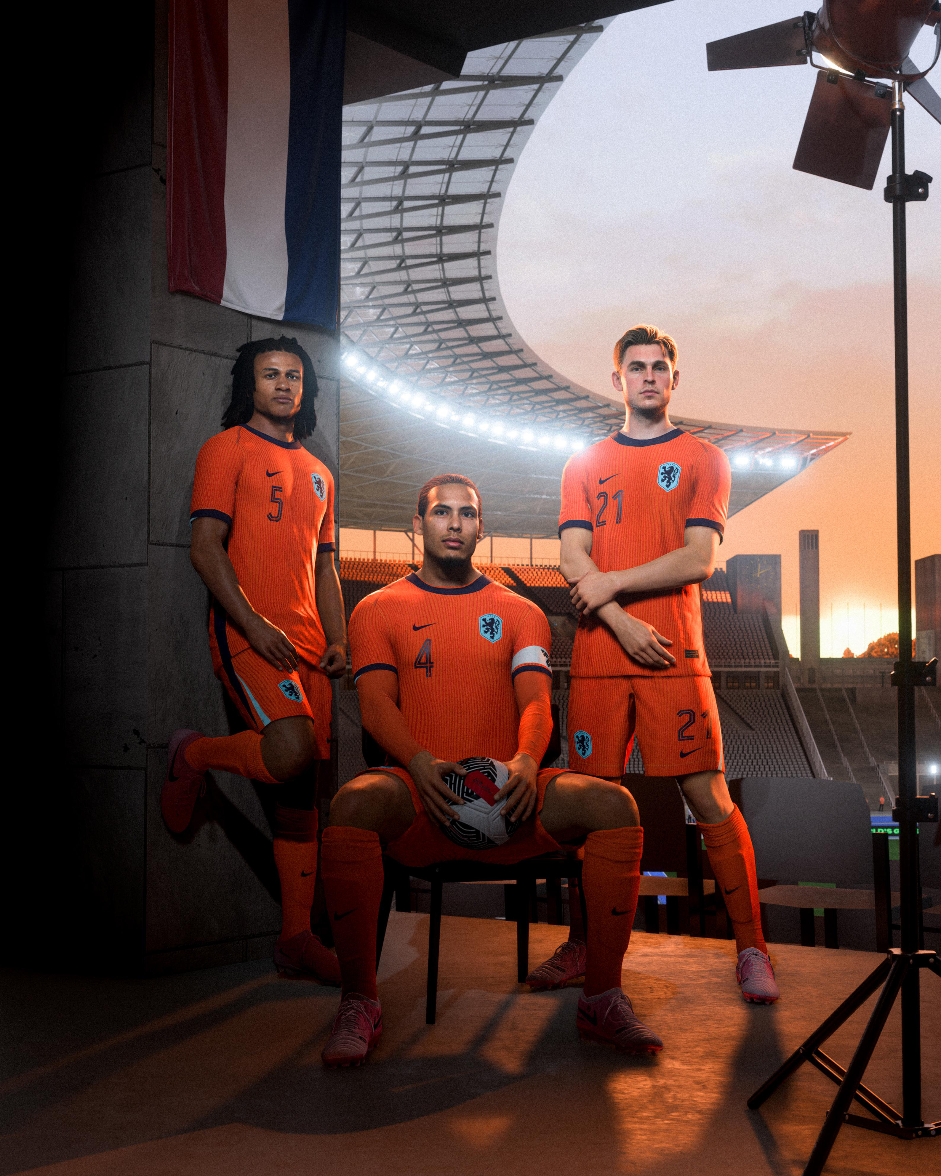 Drei Fußballspieler in orangefarbenen Trikots in einem Fotostudio.