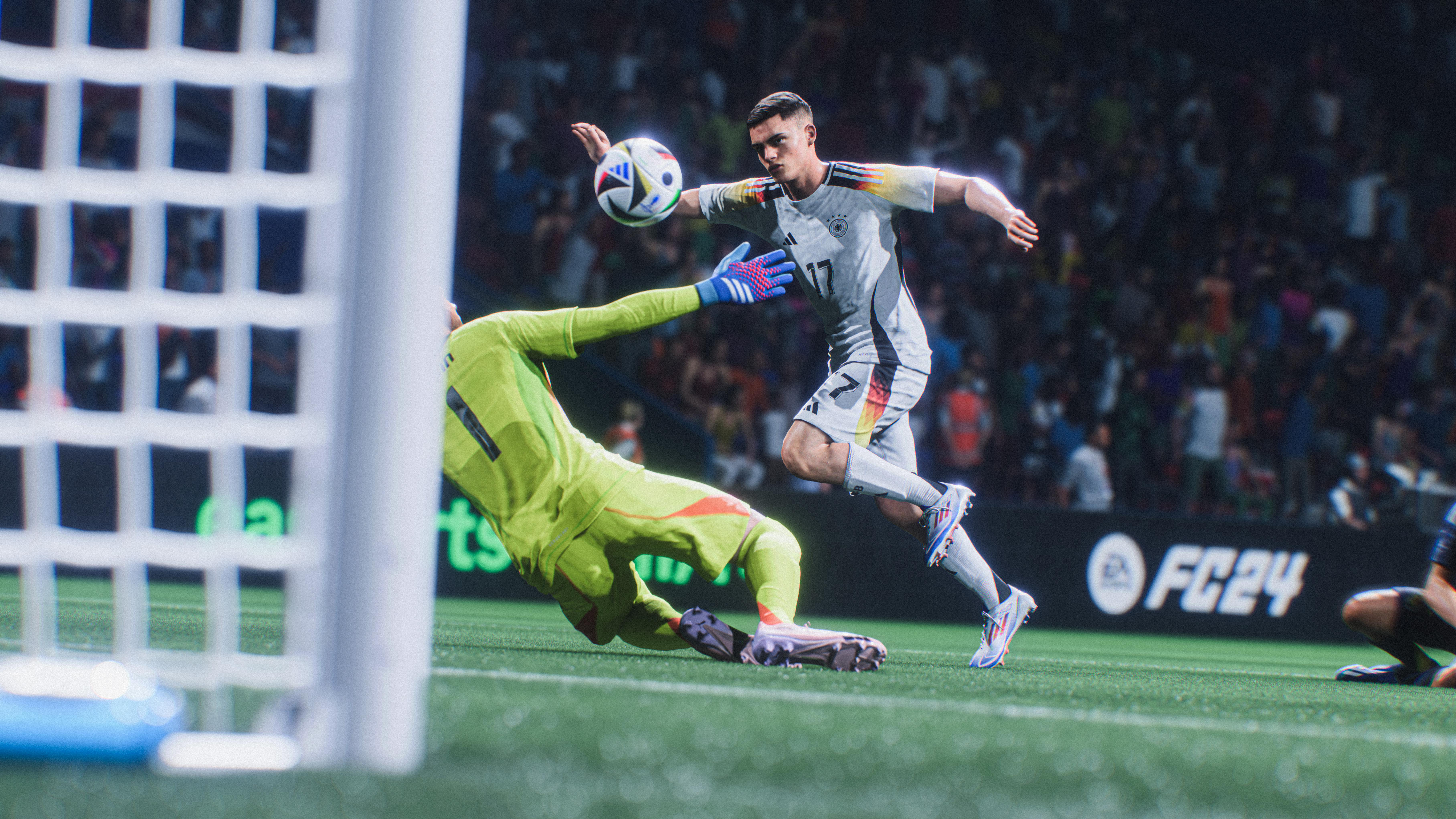 Eine Fußballspielszene aus FIFA 24. Ein Torwart springt, um einen Schuss eines Spielers abzuwehren.