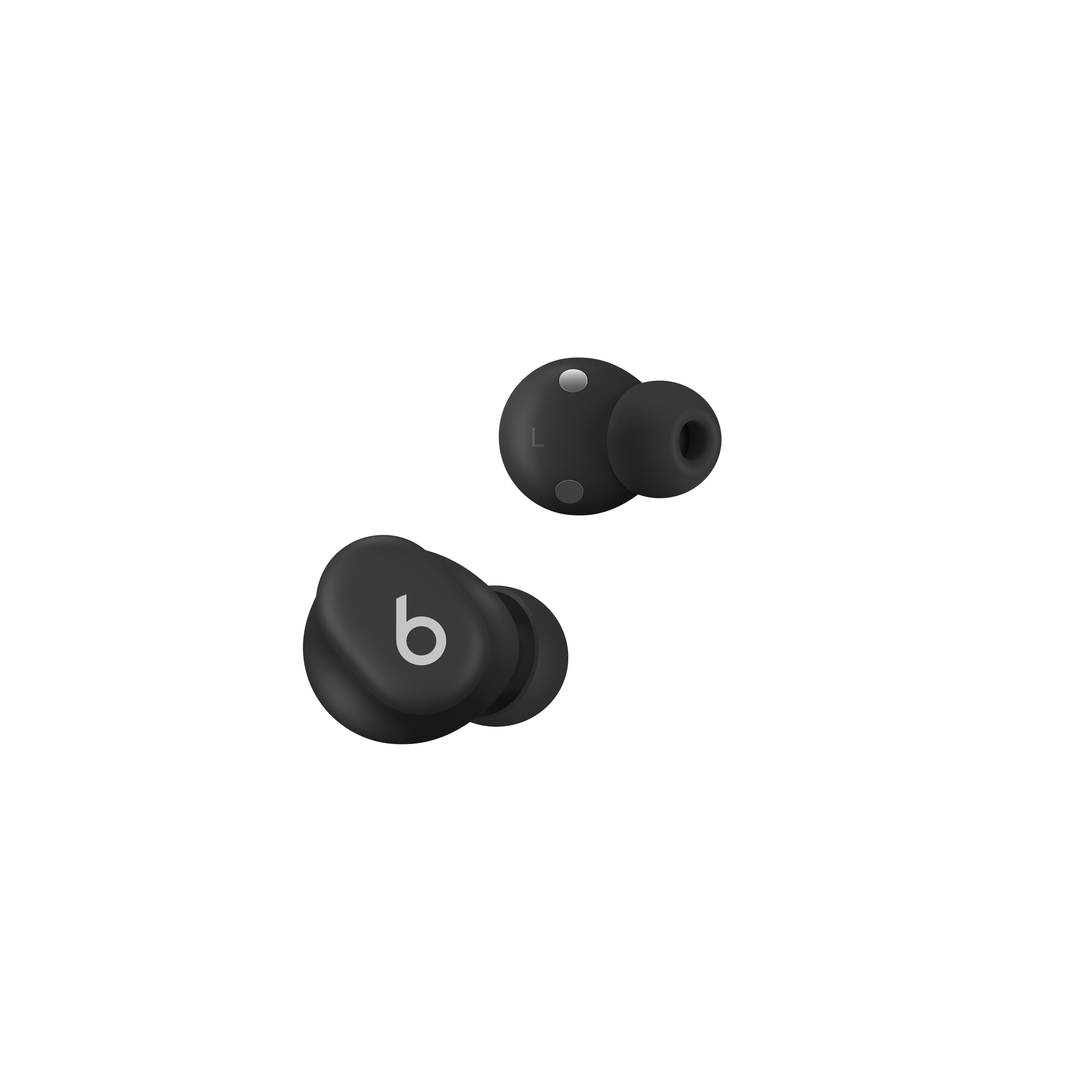 Auriculares Beats negros. Un auricular muestra el logotipo 'b'. El otro tiene un punto plateado. Fondo blanco.