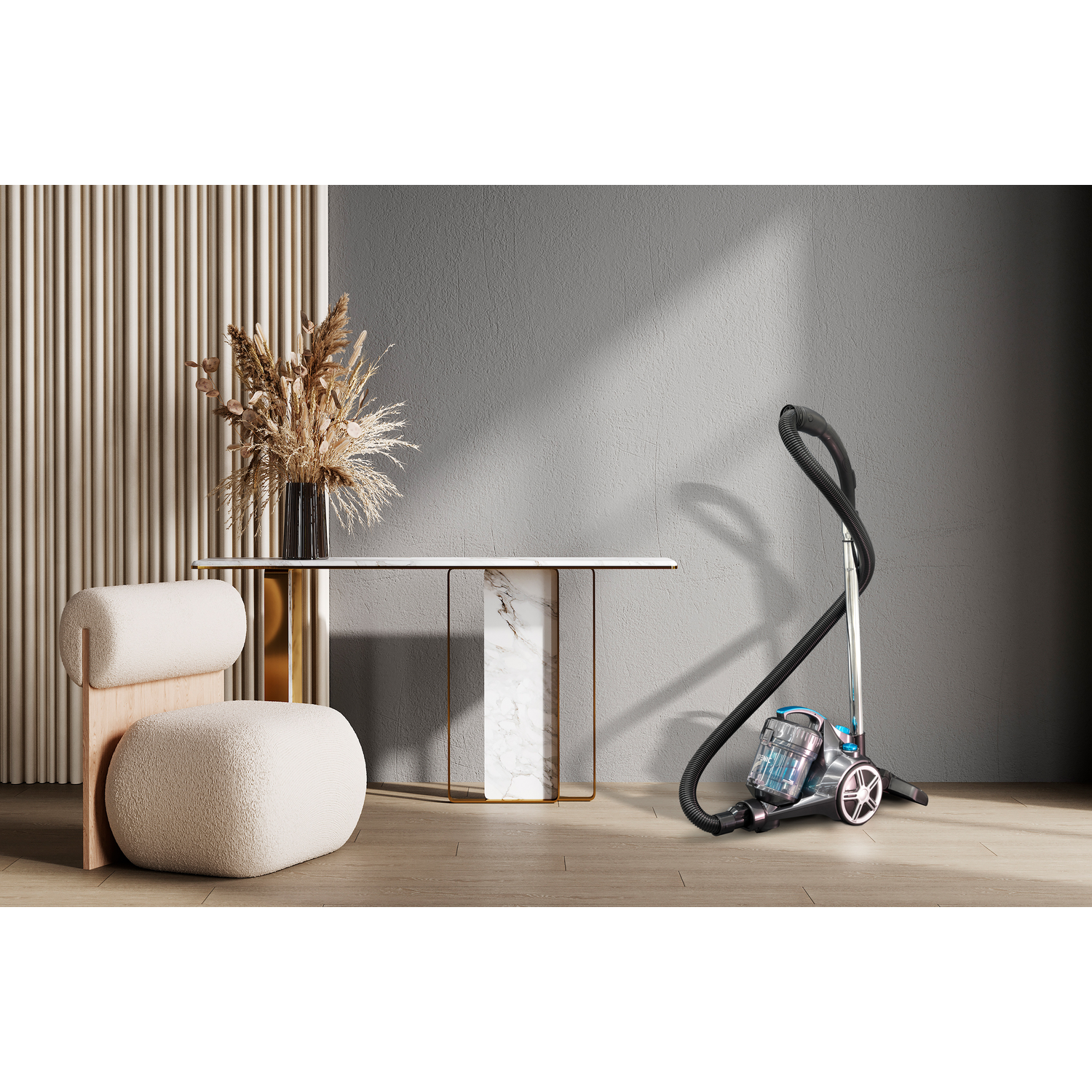 A vacuum cleaner next to a chair and a table. A vase with flowers is on the table.