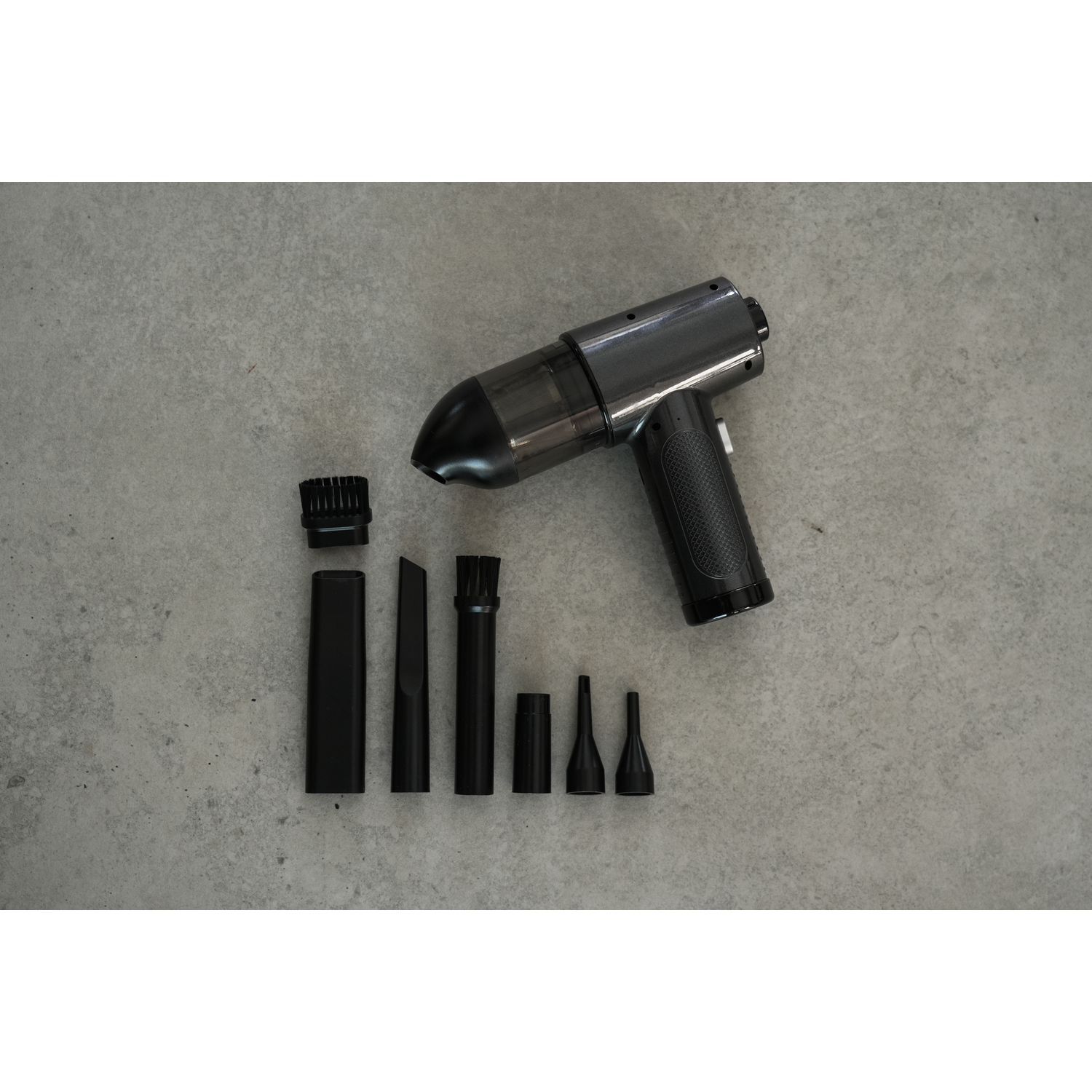 Black handheld vacuum cleaner with attachments. Accessories include brush, nozzles, and crevice tool.