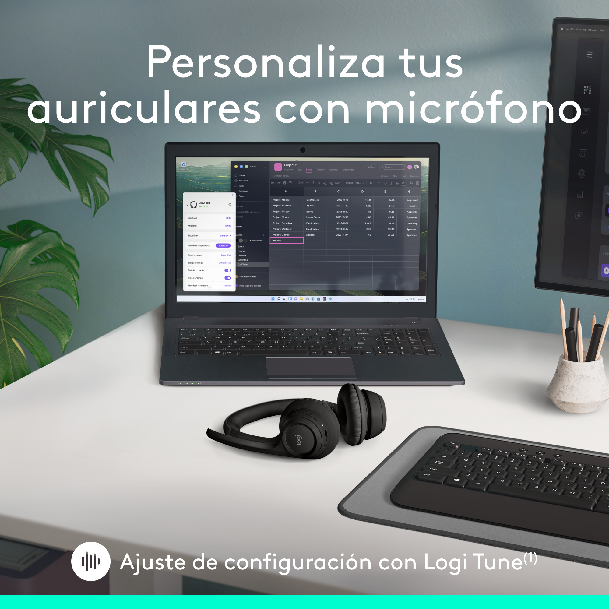 Un portátil con pantalla, auriculares, teclado y alfombrilla de ratón en un escritorio.