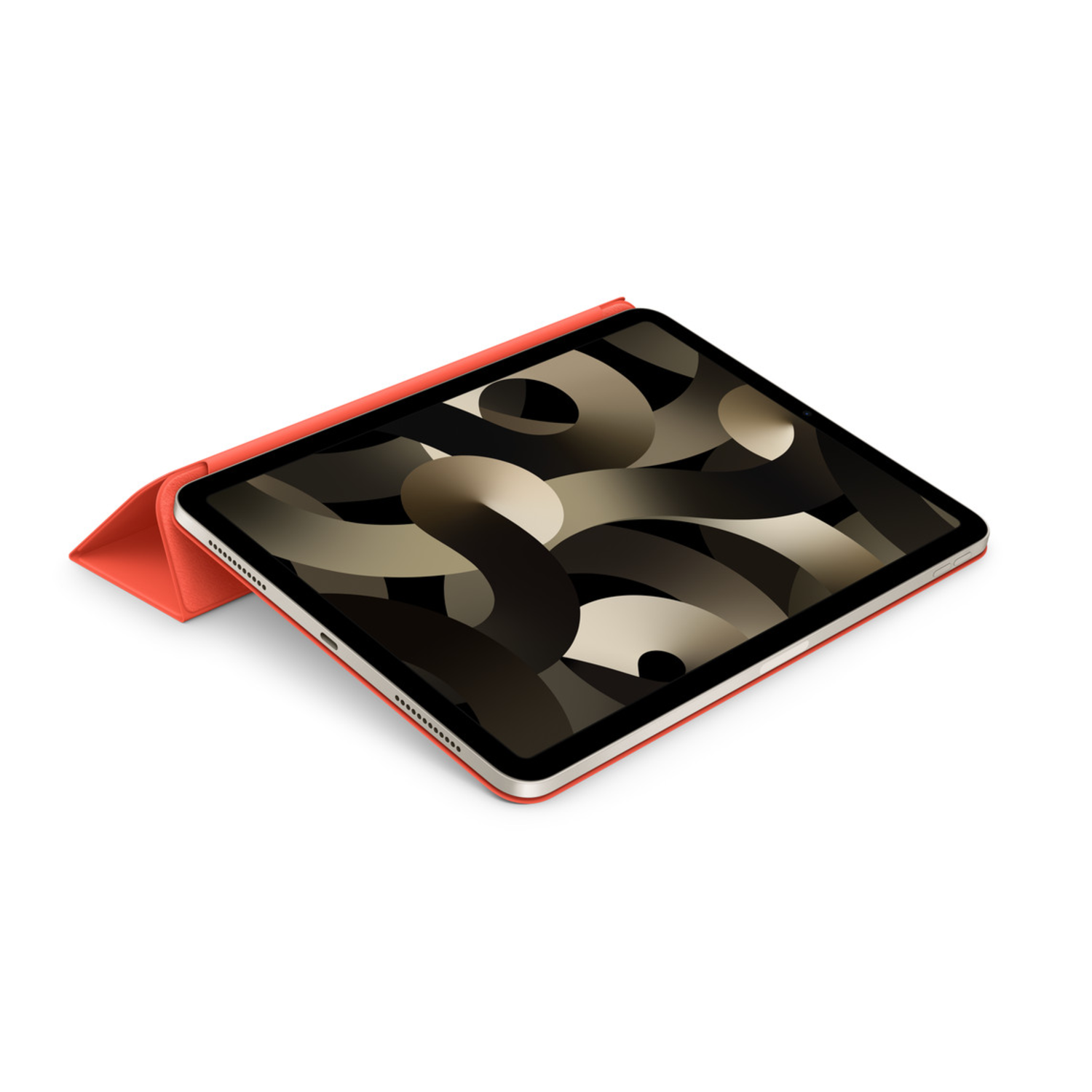 iPad with a red cover is lying on a white surface. The screen shows a dark abstract pattern.