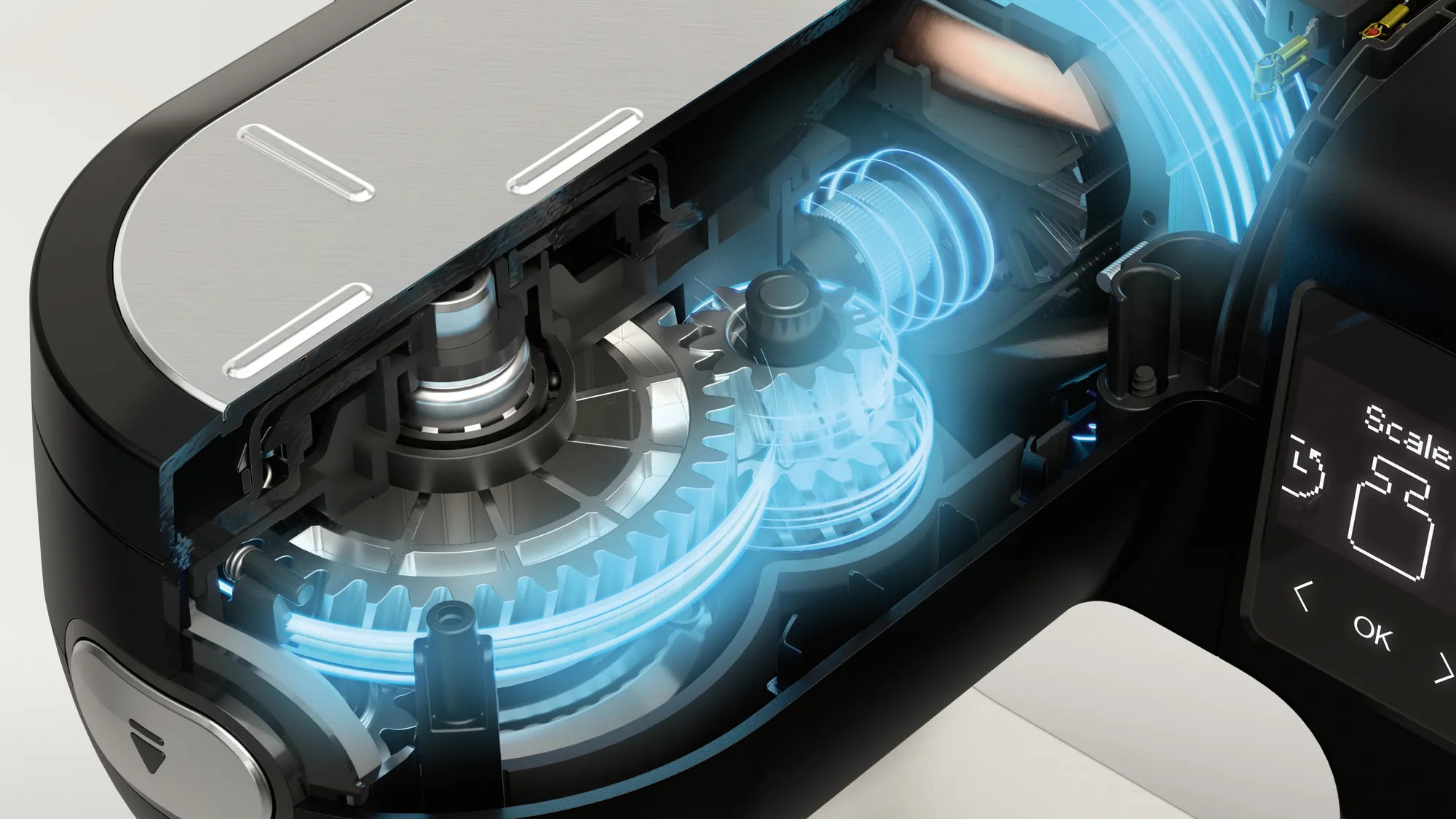 Przekrój wewnętrznego mechanizmu urządzenia, z zębatkami i niebieskimi elementami.