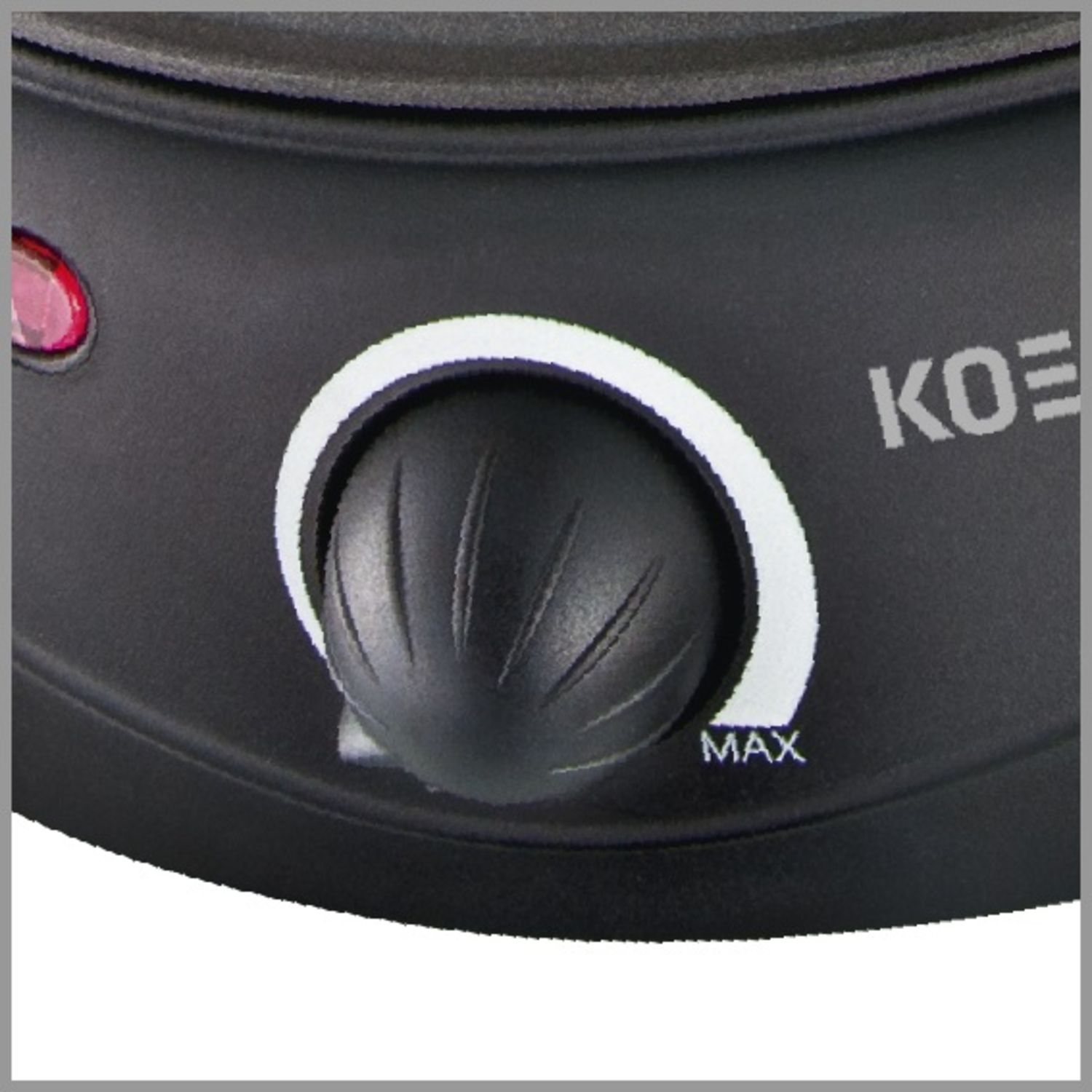 A close-up of a black knob with a white outline set on a black surface, with MAX label.