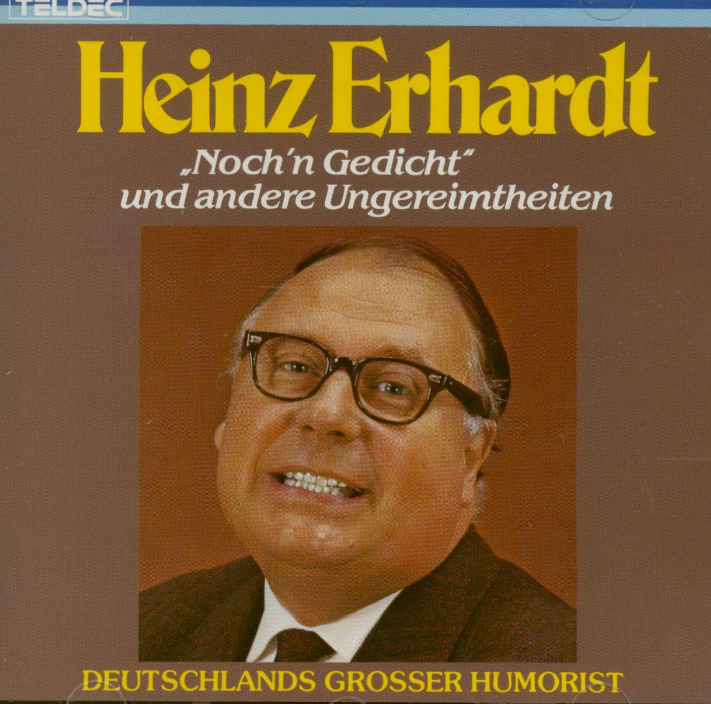 Heinz Erhardt lächelt, trägt eine Brille, in einem braunen Anzug. Text in Gelb und Weiß.