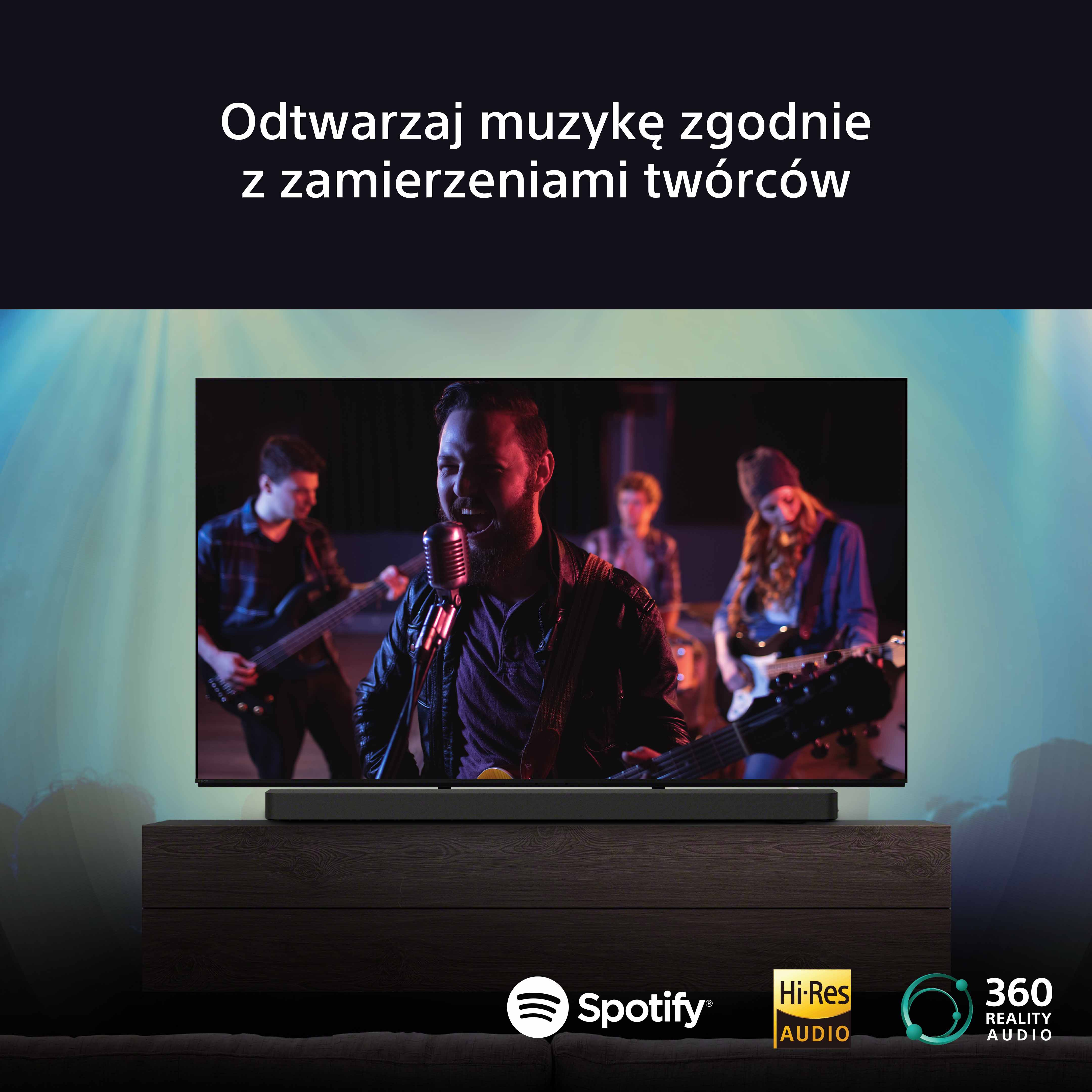 Telewizor wyświetla zespół grający muzykę. Scena ma ciemną drewnianą szafkę i głośnik.