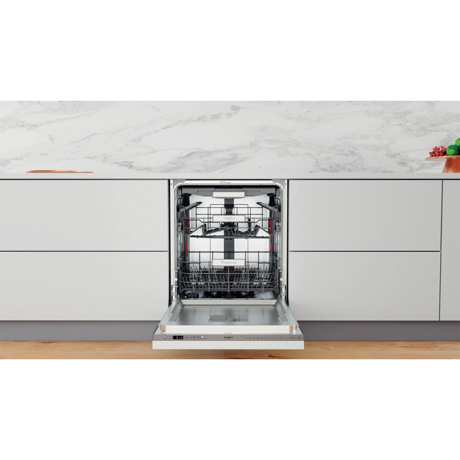 Una lavastoviglie aperta in una cucina con piano di lavoro in marmo e pavimento in legno.