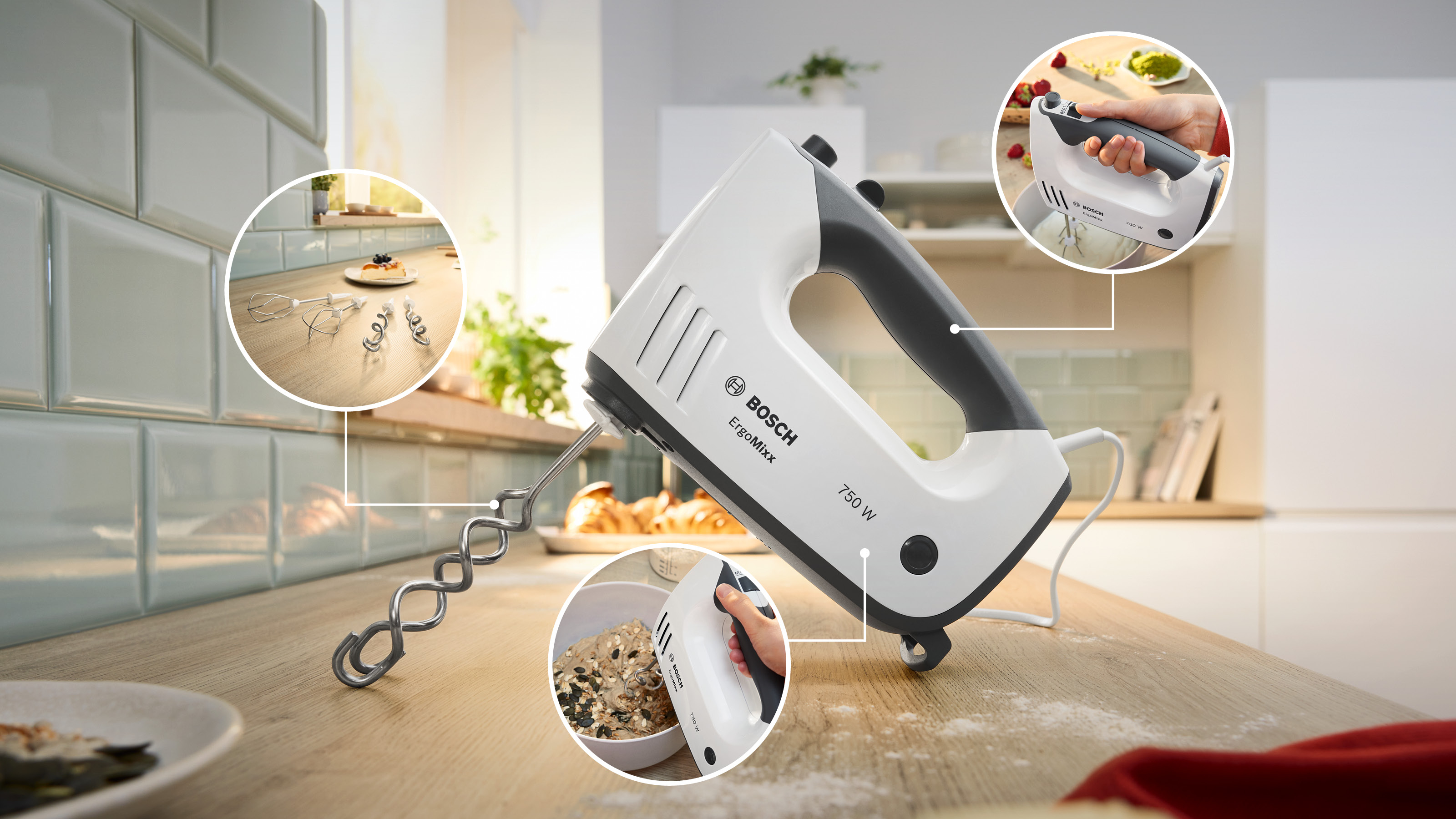 Bosch ErgoMixx Handmixer mit Aufsätzen auf einer Holz-Arbeitsplatte mit Küchendetails.