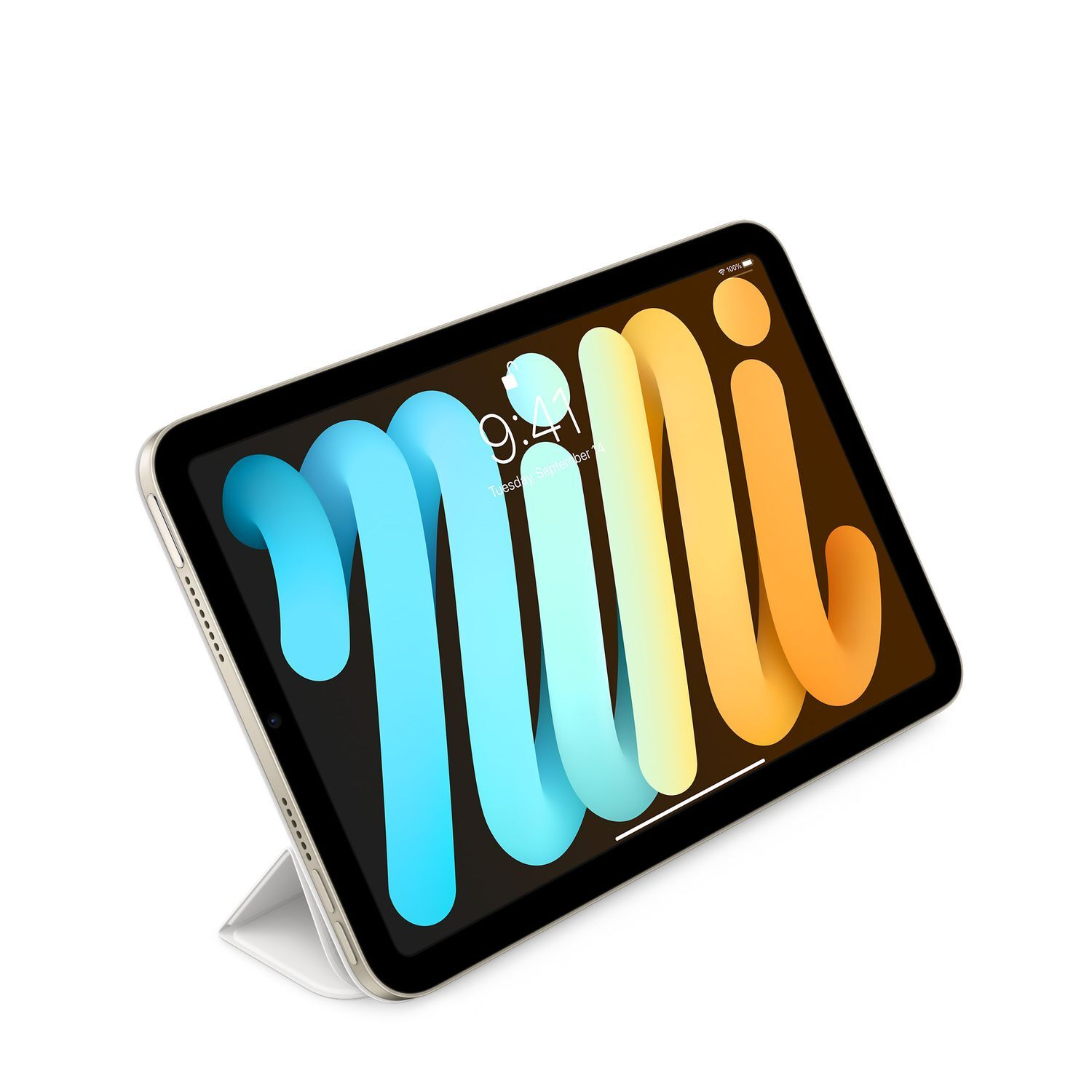 Tablet leaning on a stand. The screen is on, and the device is gold and white.