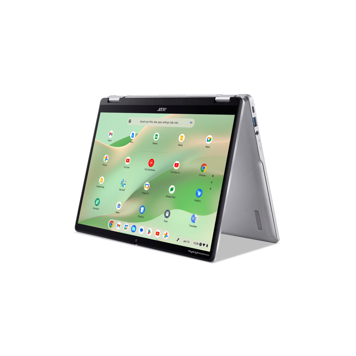 Silver laptop with a screen displaying apps. It's open and on a dark surface.
