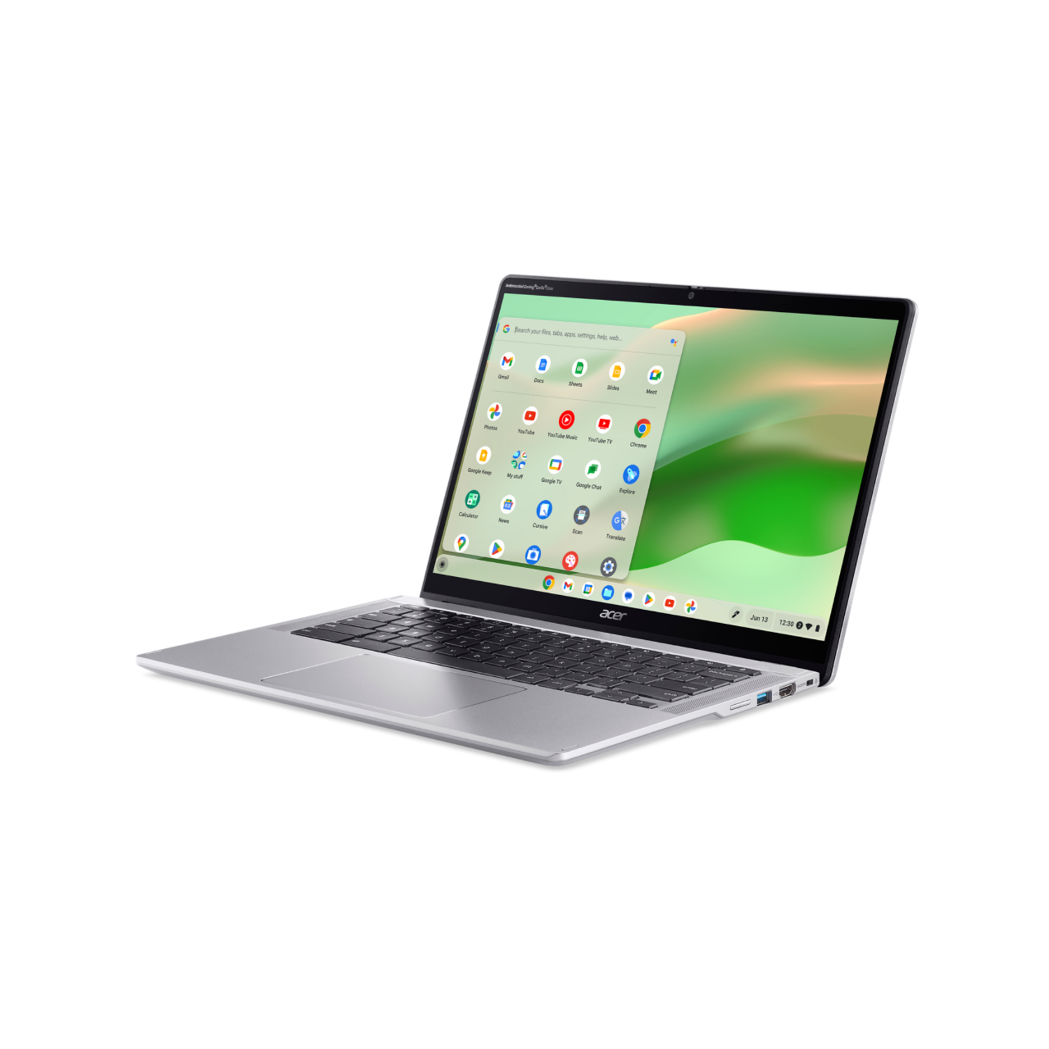 A silver laptop on a black surface, screen showing a desktop with icons.