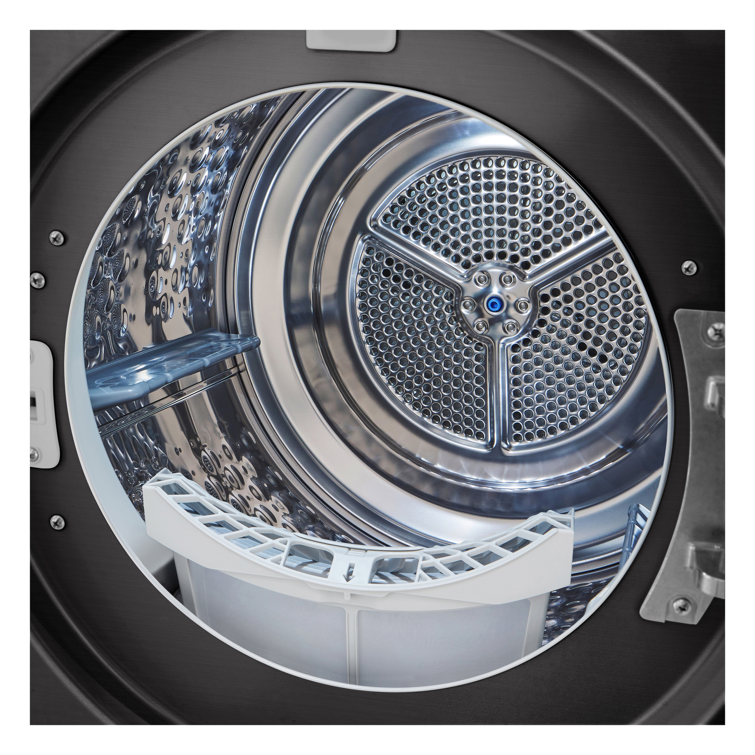 Inside of a washing machine drum, silver, with a white filter and black exterior.