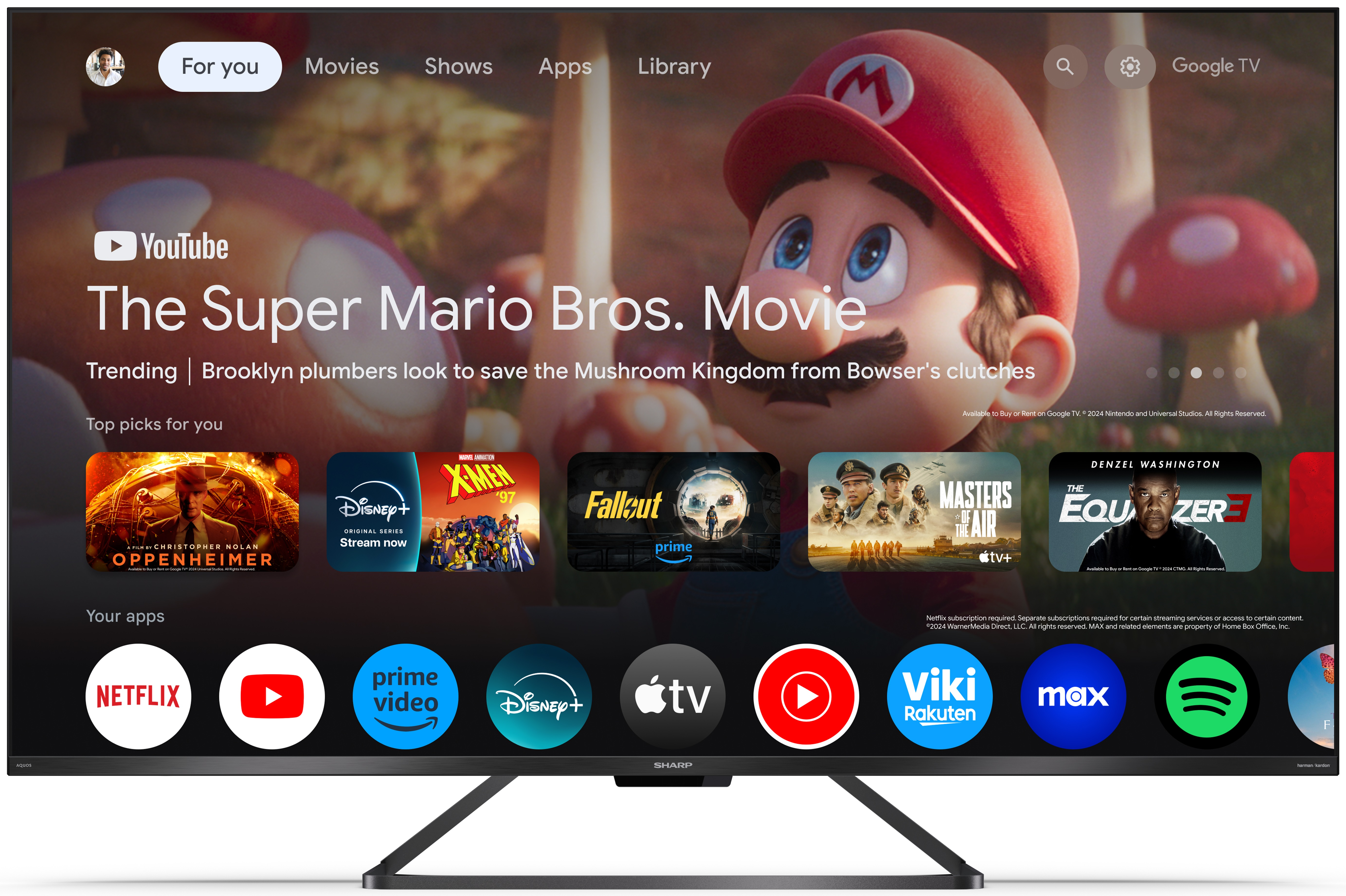 Ekran telewizora wyświetlający interfejs filmu Super Mario Bros. z ikonami aplikacji i sugestiami filmów.