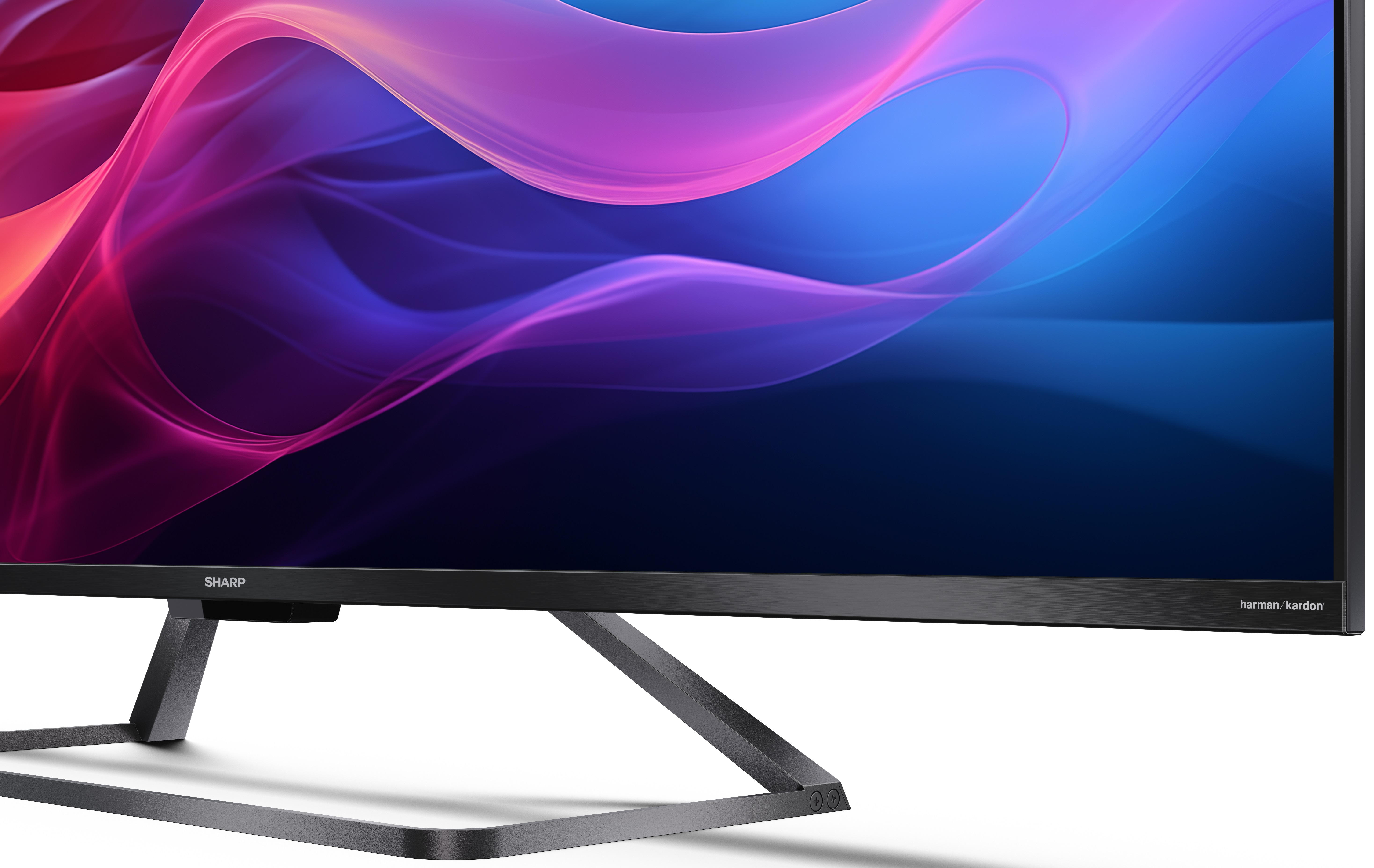 Monitor Sharp ze stojakiem i kolorowym tłem.