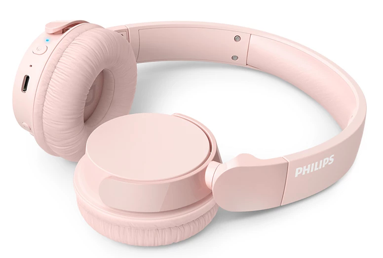 Różowe słuchawki nauszne z logo Philips na białym tle.