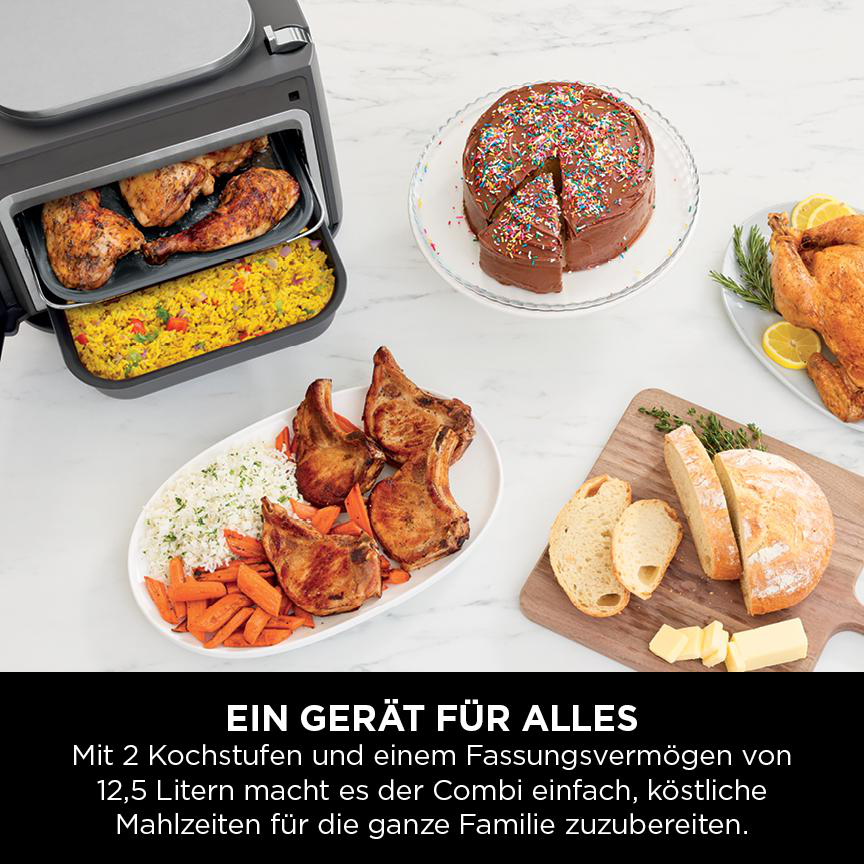 Verschiedene gekochte Speisen wie Hähnchen, Kuchen und Fleisch in einem Küchengerät angeordnet.