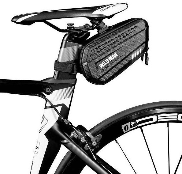 Czarna torba podsiodłowa przymocowana do roweru, z elementem odblaskowym.