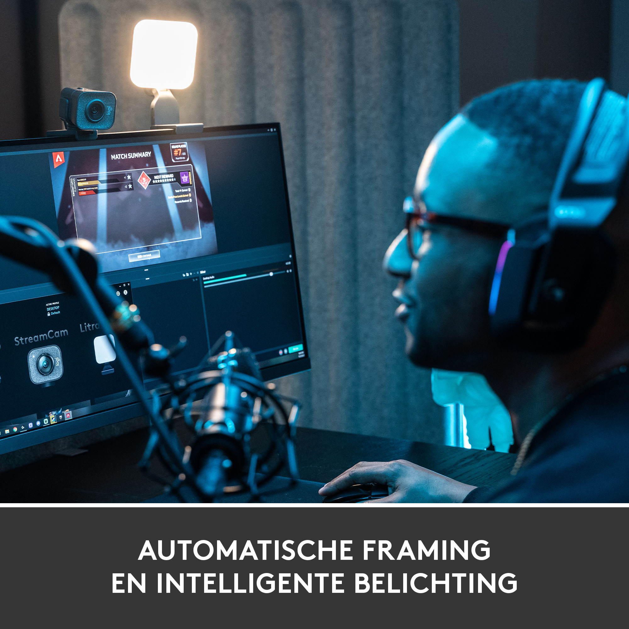 A man is streaming with a computer, microphone, and a light.