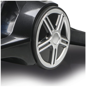 Close-up of a vacuum cleaner wheel, showing a silver rim and a black tire.