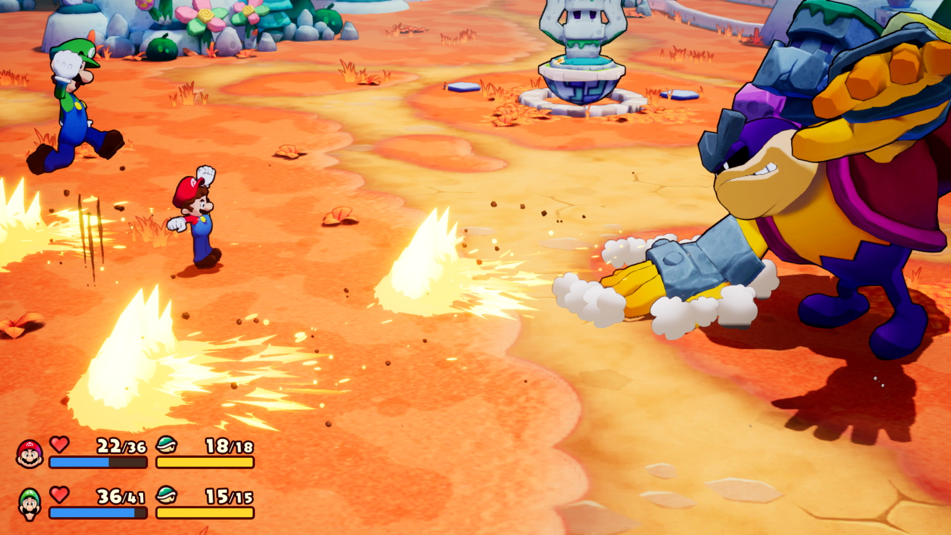 Scena di videogioco con Mario e Luigi che combattono contro un grande nemico, con effetti energetici e barre della salute.
