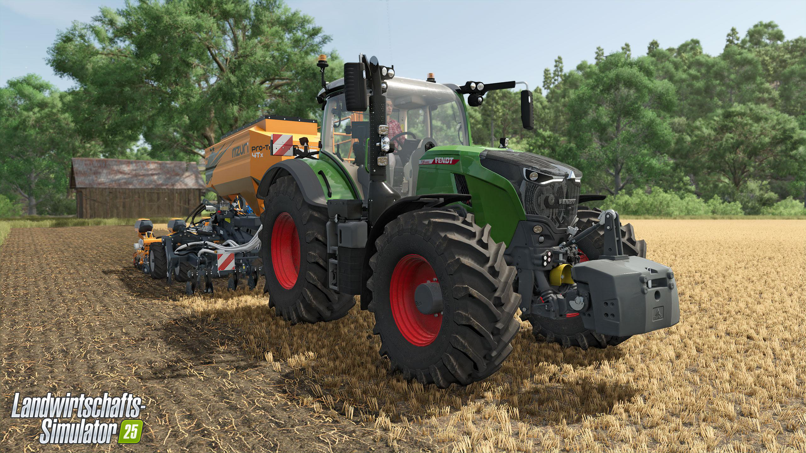Ein grüner und schwarzer Traktor mit gelbem Anhänger auf einem Feld.