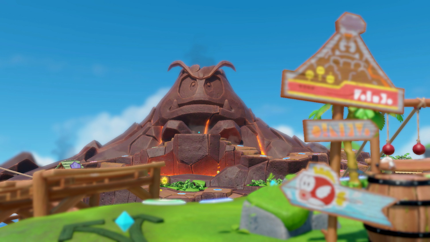 Een cartoonachtige vulkaan met een uilengezicht, omringd door een game-scène met borden en structuren.