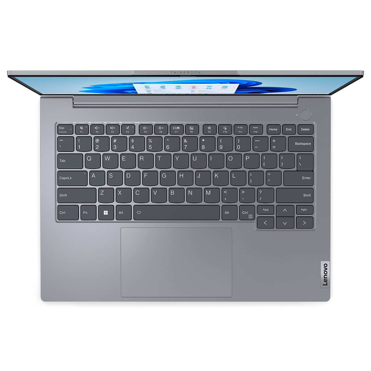 Un portátil gris con el teclado hacia arriba.