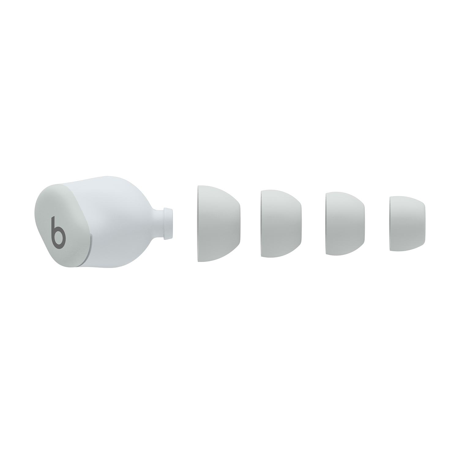 Auricolari Beats e gommini. Gli auricolari sono bianchi con logo 'b', i gommini in fila.