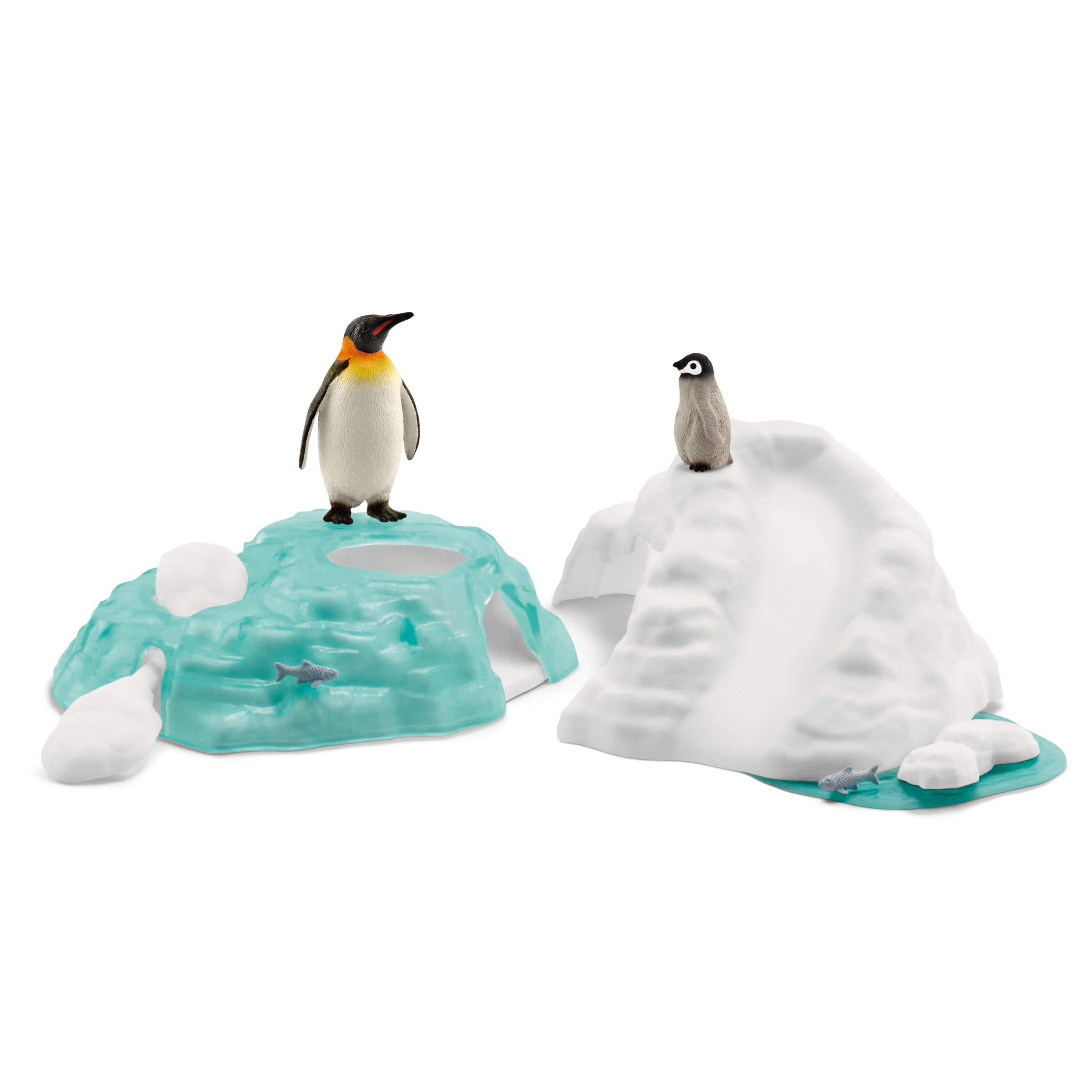 Zwei Spielzeugpinguine auf Eisformationen. Einer steht hoch.