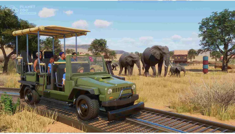 Een safari jeep op een spoor met mensen, olifanten en bomen in een dierentuin.