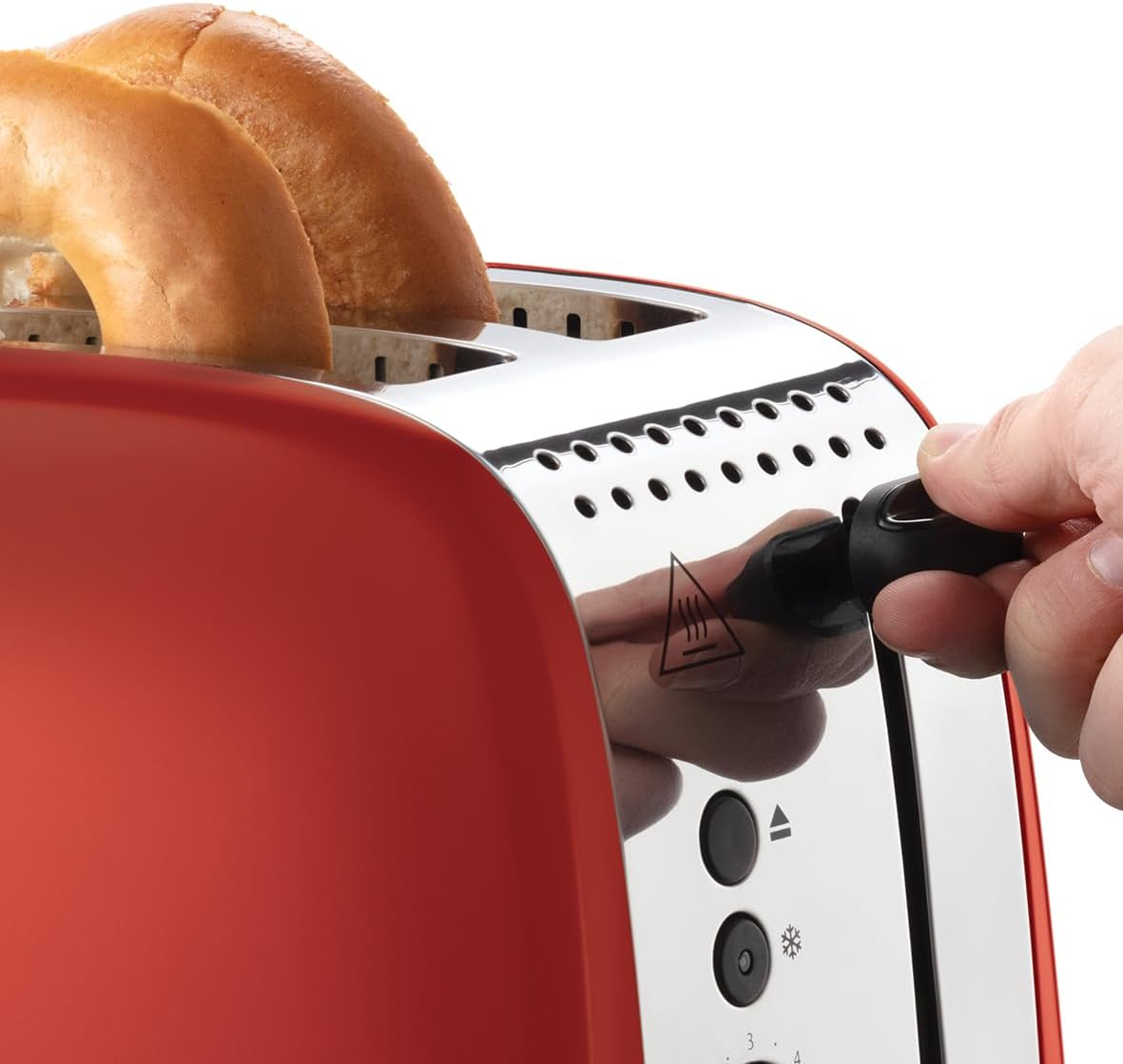 Tostadora roja con dos bagels dentro. Una mano gira un dial negro.