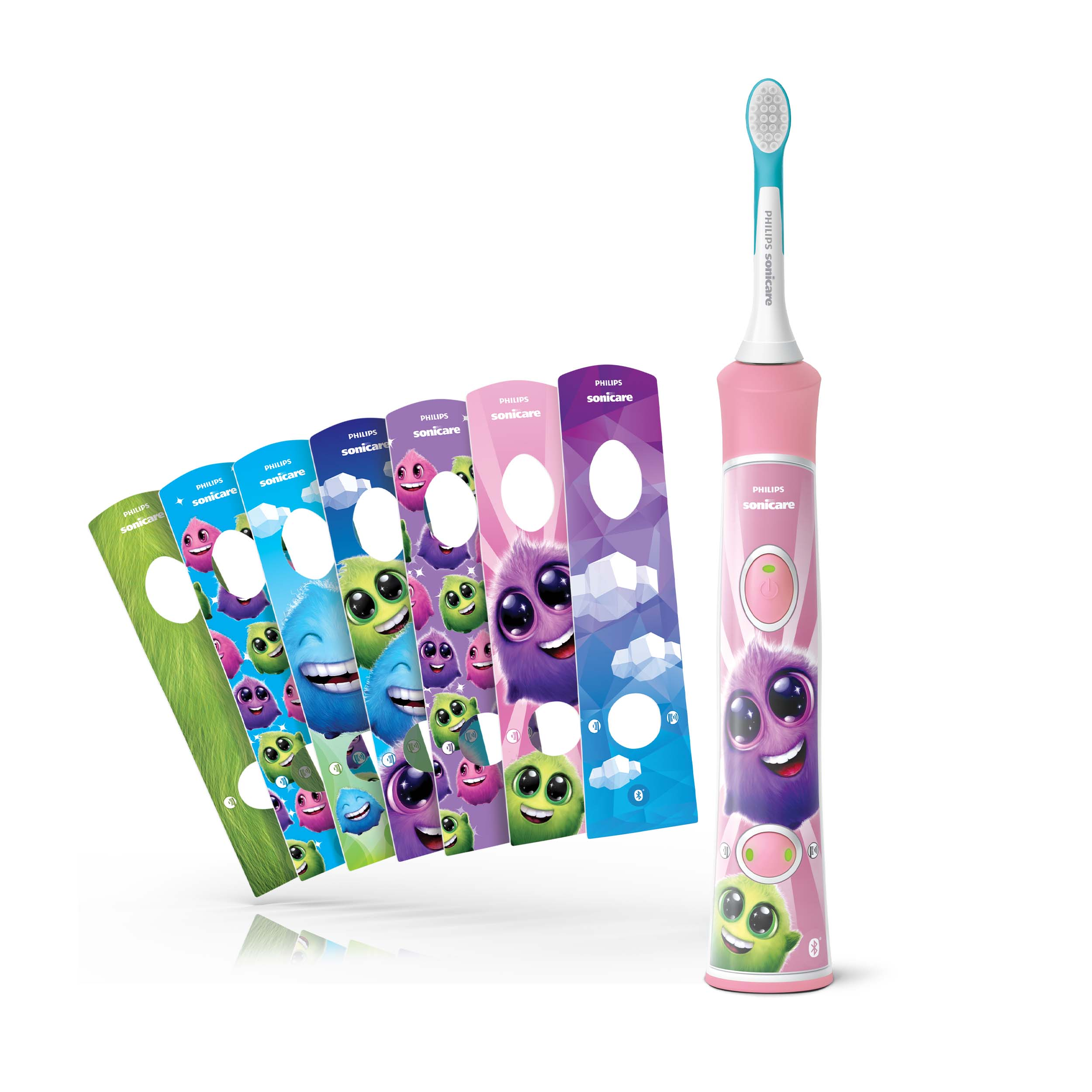 Różowa szczoteczka do zębów Philips Sonicare i kilka kolorowych osłon głowic szczoteczki z motywem potworów.