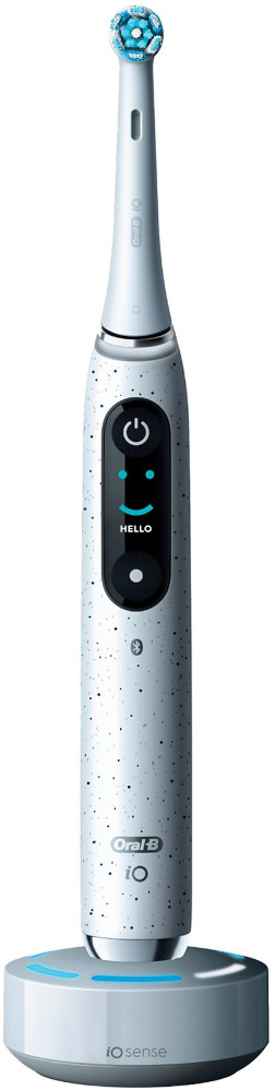 Une brosse à dents électrique sur une base de chargement, avec un affichage numérique et le mot 'hello'.
