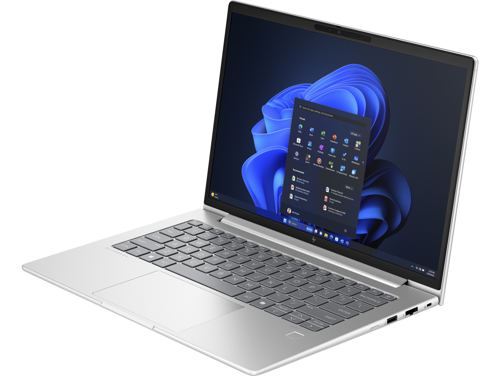 Laptop en un escritorio. La pantalla muestra una interfaz de Windows, fondo oscuro.