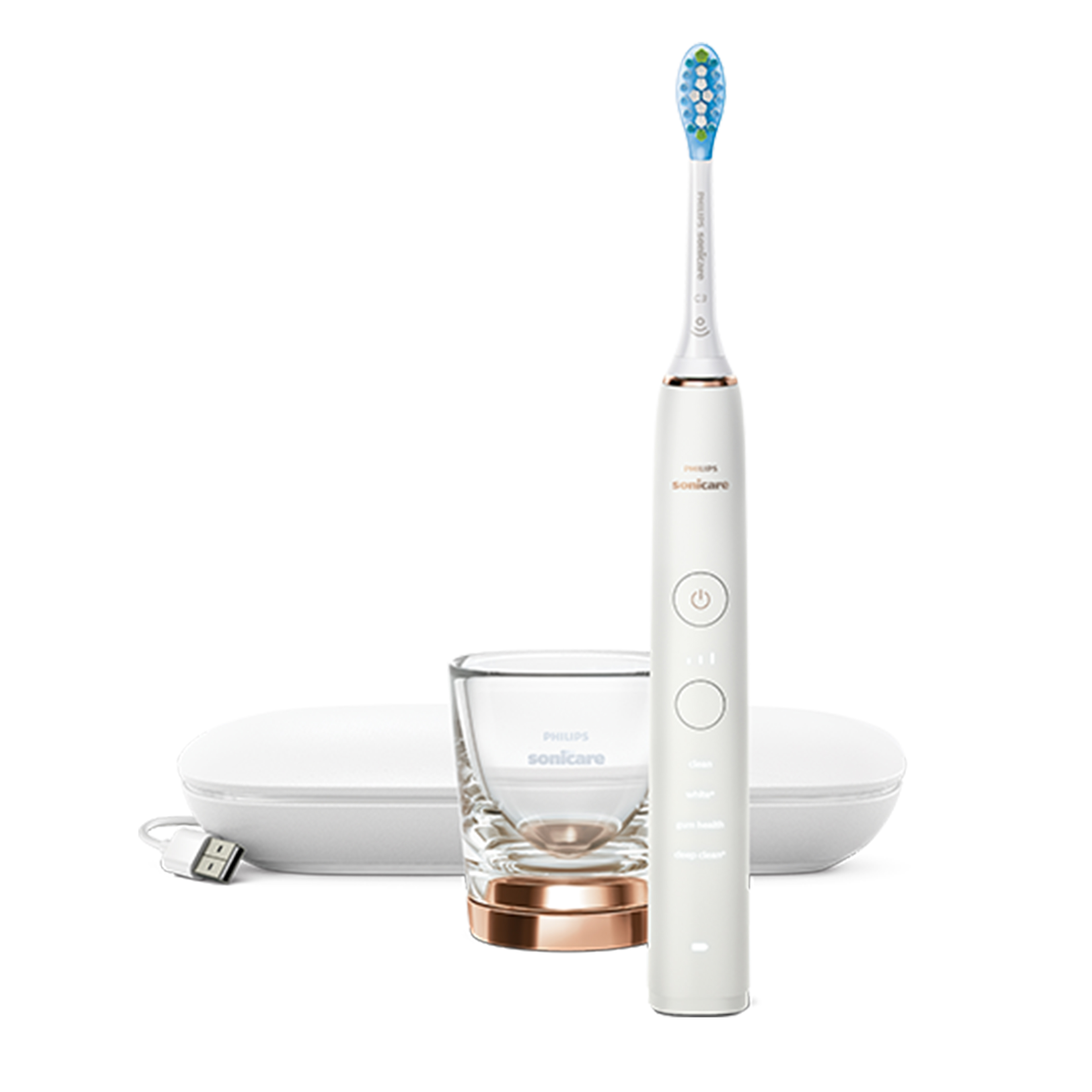 Biała elektryczna szczoteczka do zębów, stacja ładująca i przezroczysty szklany kubek ze złotą podstawą.