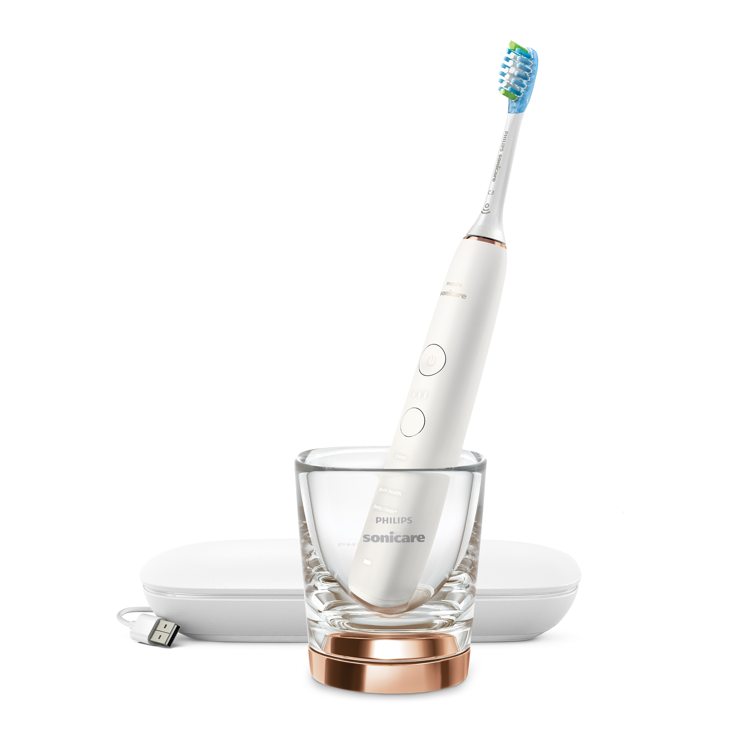 Biała szczoteczka elektryczna w szklance. Stacja ładująca i etui podróżne w pobliżu.