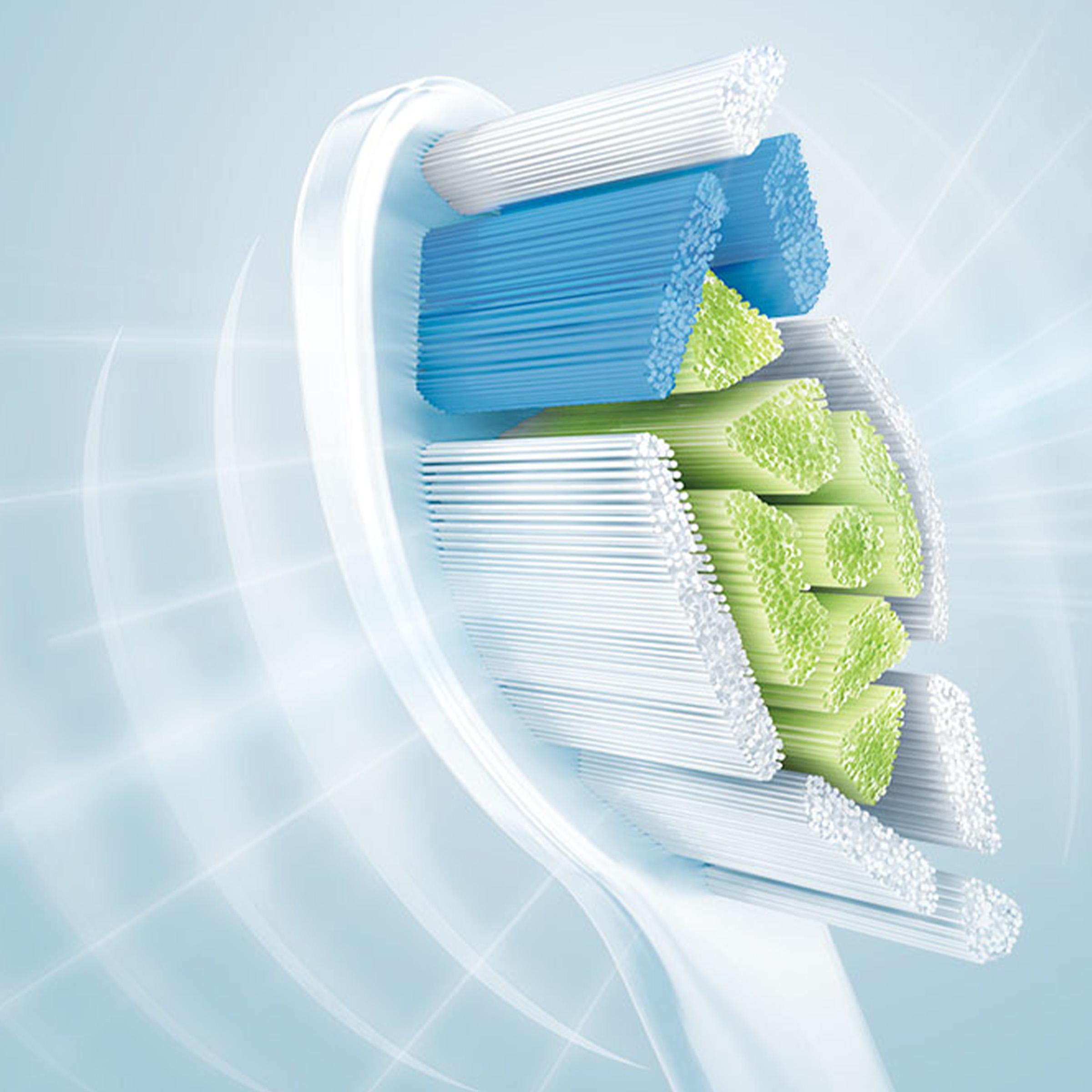 Zbliżenie główki szczoteczki do zębów, z niebieskim, zielonym i białym włosiem.