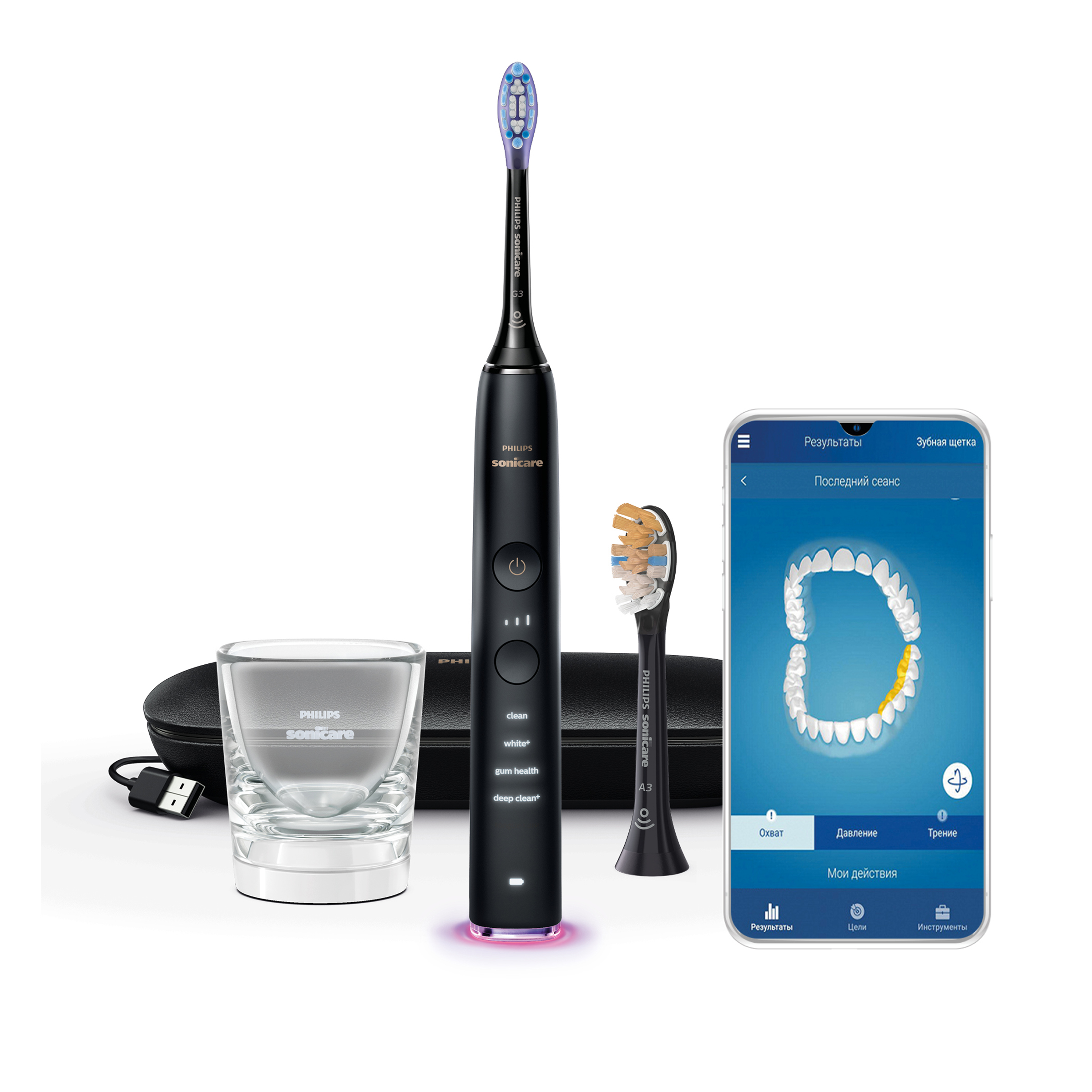 Czarna szczoteczka Philips Sonicare, szklanka, dwie końcówki i ekran telefonu.
