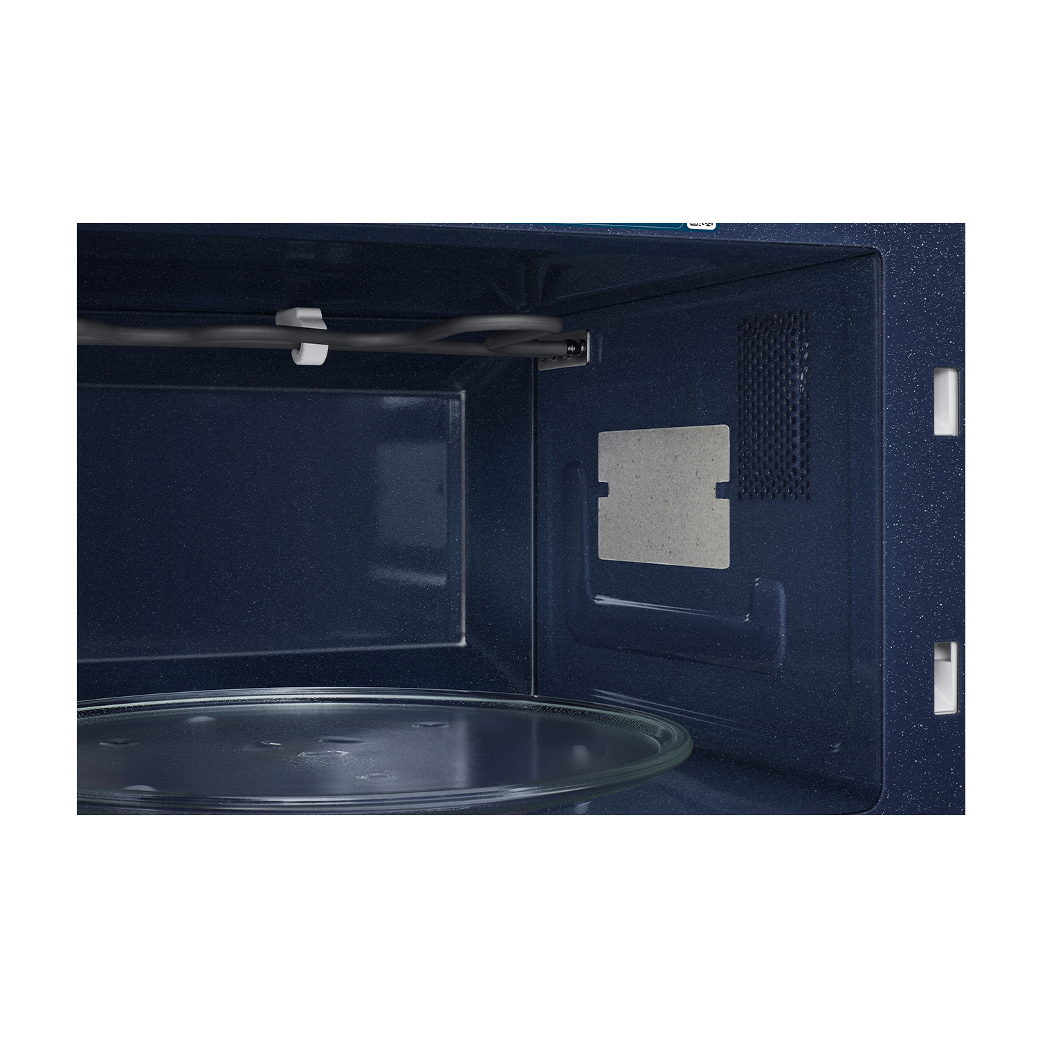 Interno di un forno a microonde nero con piatto in vetro e elemento grill.