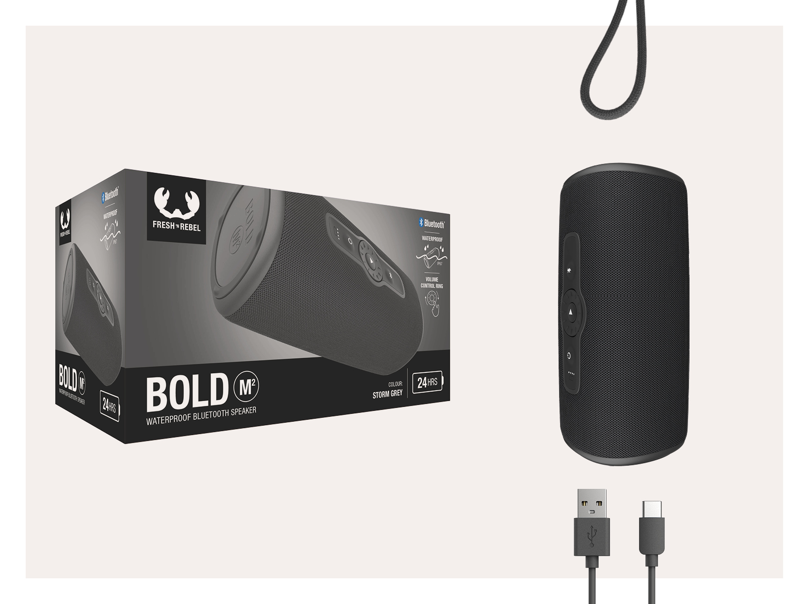 Black speaker in front of a box. USB and USB-C cables are below.