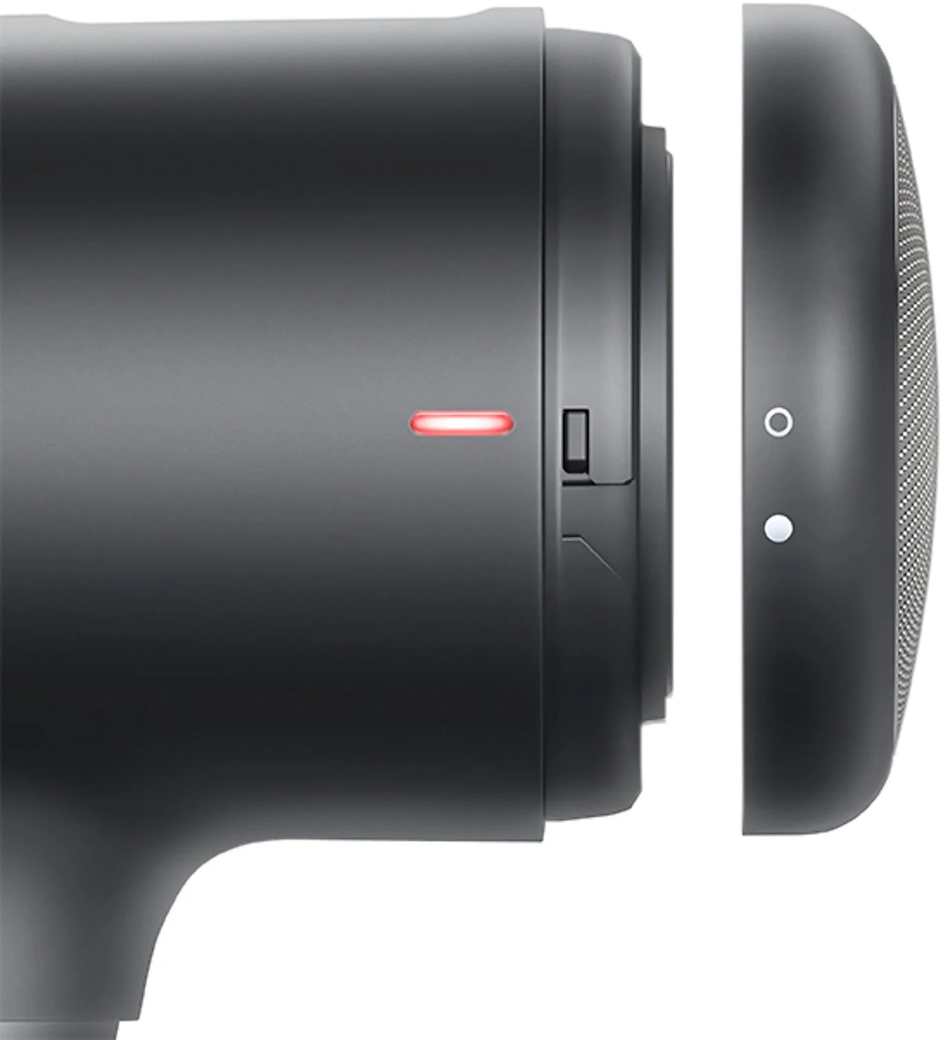 Gros plan d'un appareil noir avec une lumière rouge et un haut-parleur séparé. Fond blanc.