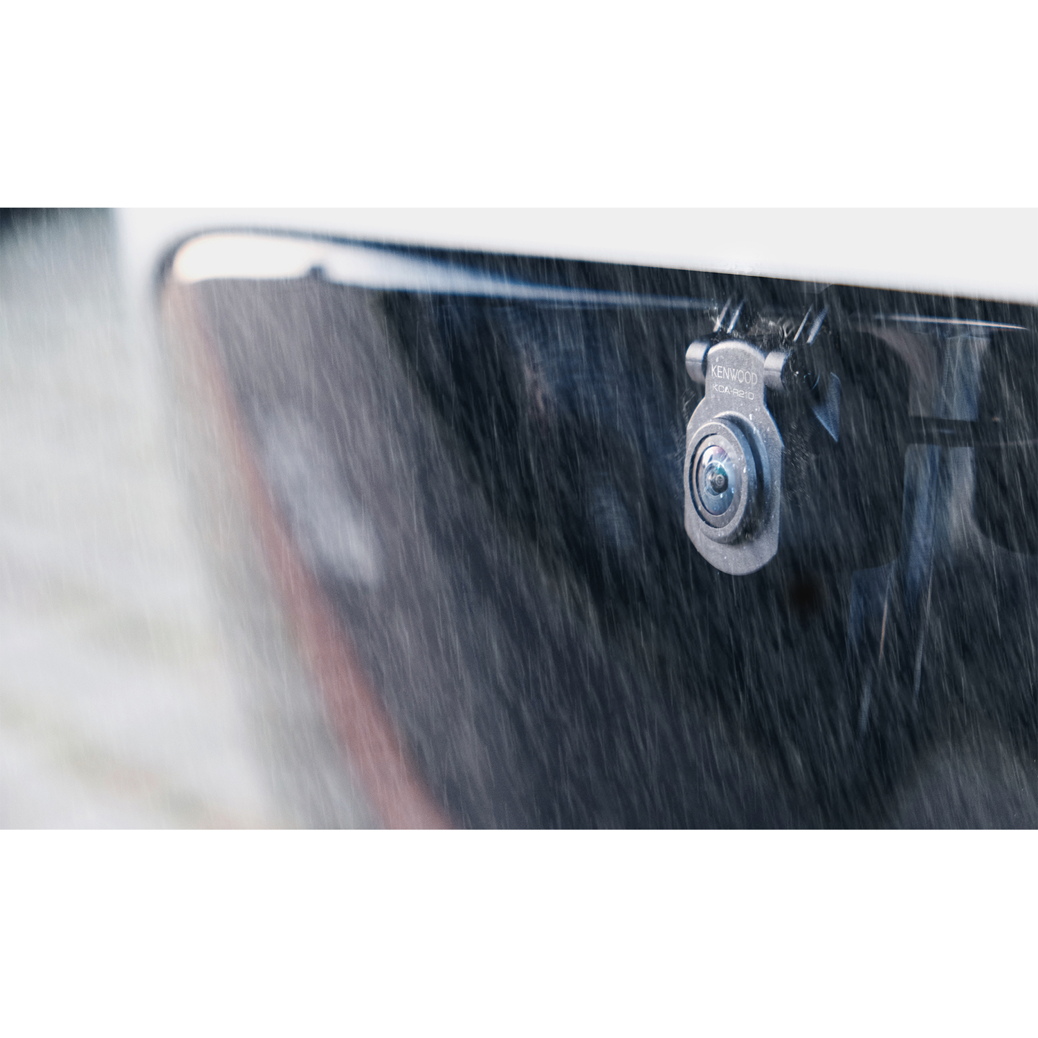 A car's rear camera under rain. The Kenwood camera is mounted on the car's rear.