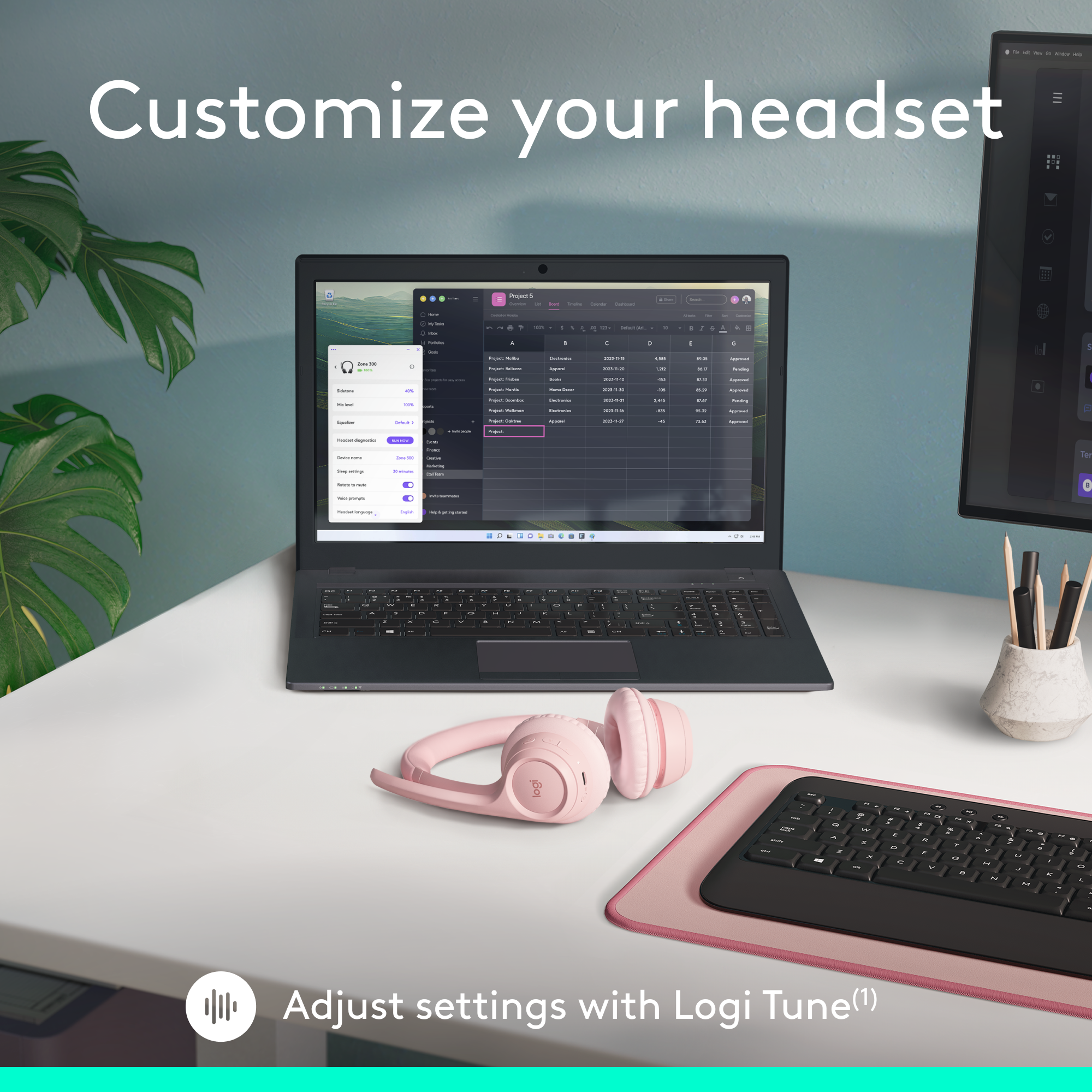 Ein Laptop mit rosa Headset und Tastatur auf einem weißen Schreibtisch.